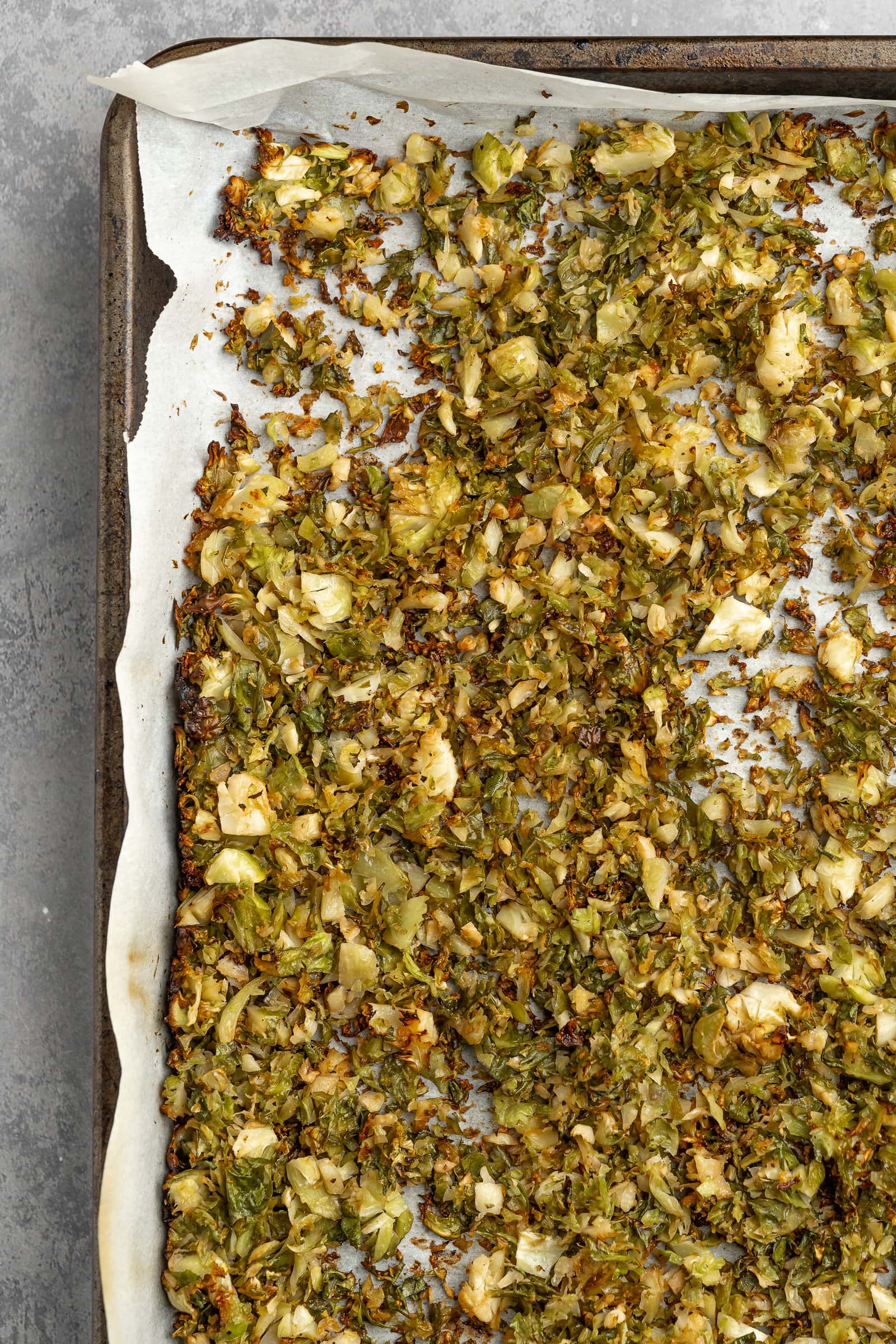 Crispy golden brown shredded Brussels sprouts on a baking tray.