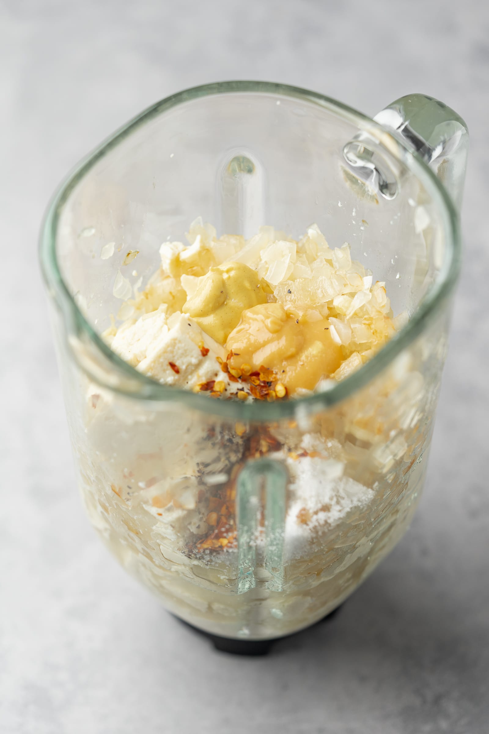 Silken tofu pasta sauce ingredients in a glass blender.