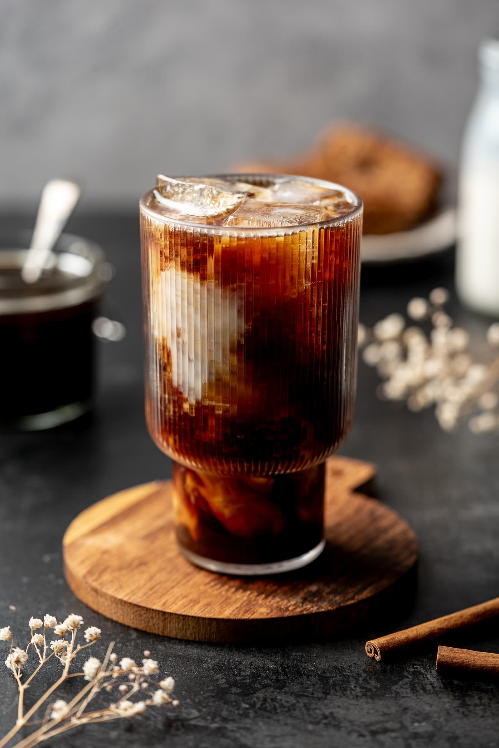 Iced coffee on a wooden cutting board.