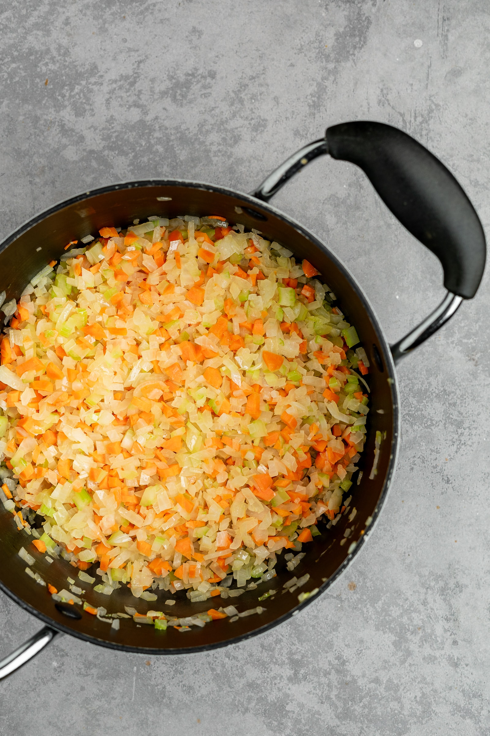 Cooked onions, celery, and carrots in a large soup pot.