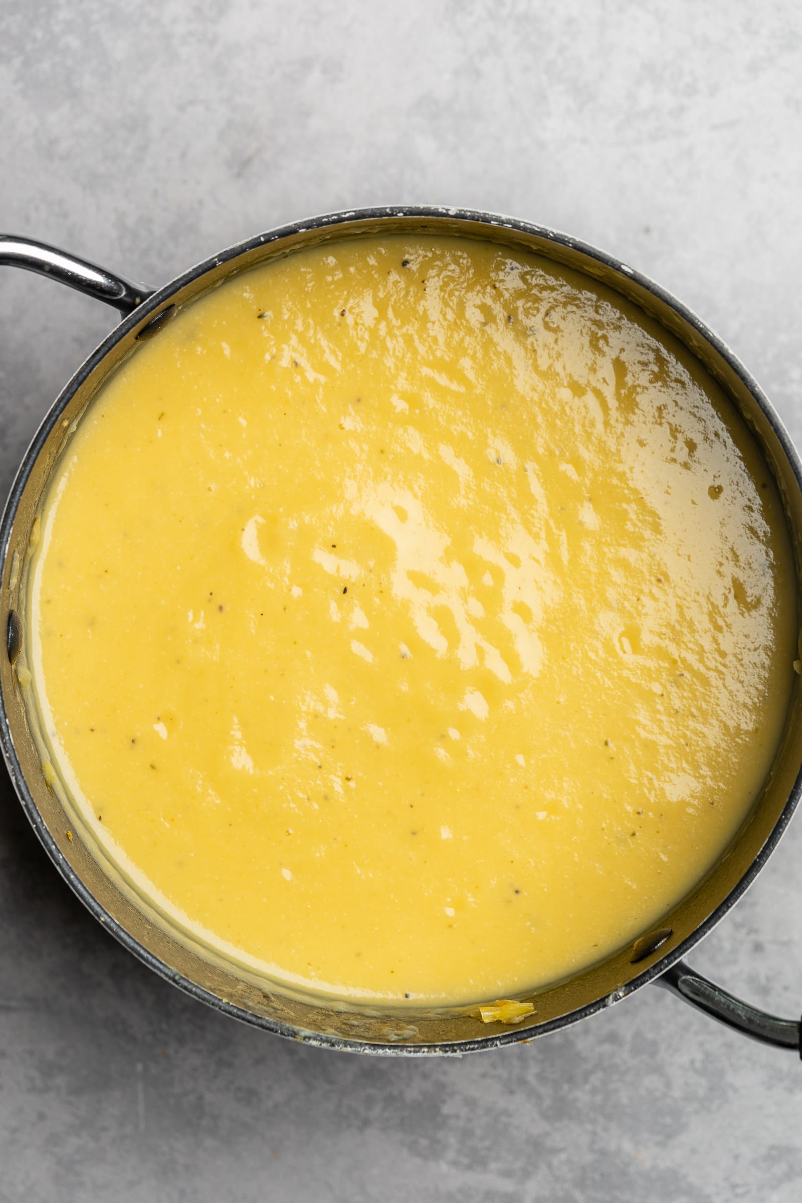 Potato leek soup after being puréed with an immersion blender in a soup pot.