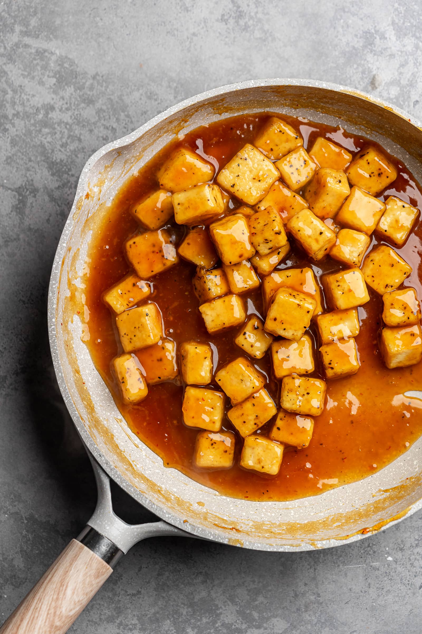 Orange tofu in a pan.