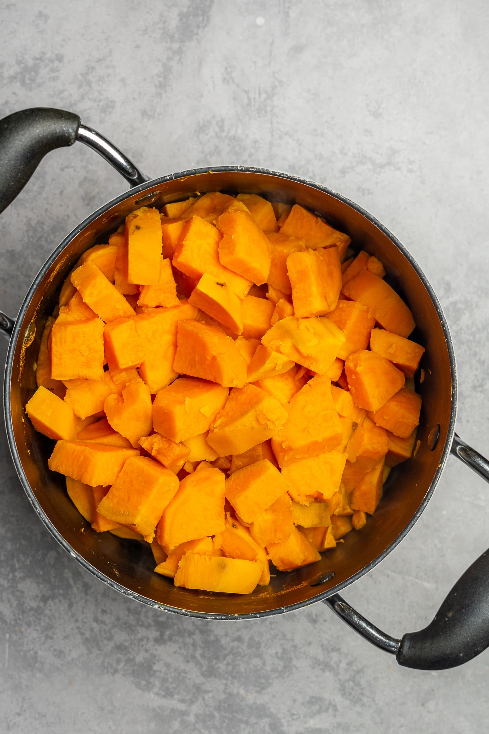 Boiled sweet potatoes in a large pot.