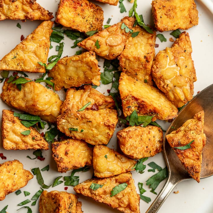 Crispy air fryer tempeh on a plate with cilantro.