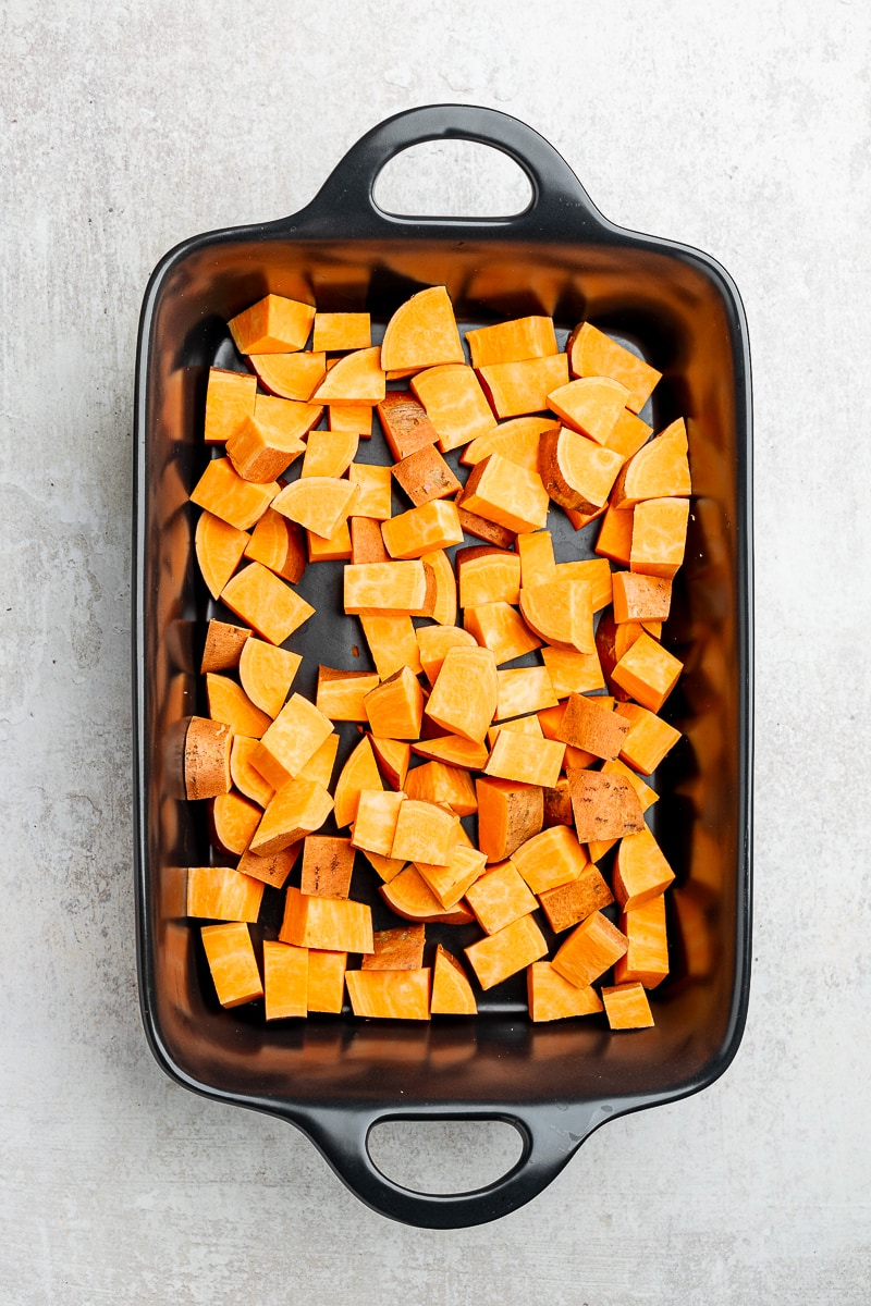 Chopped sweet potatoes in a baking dish.