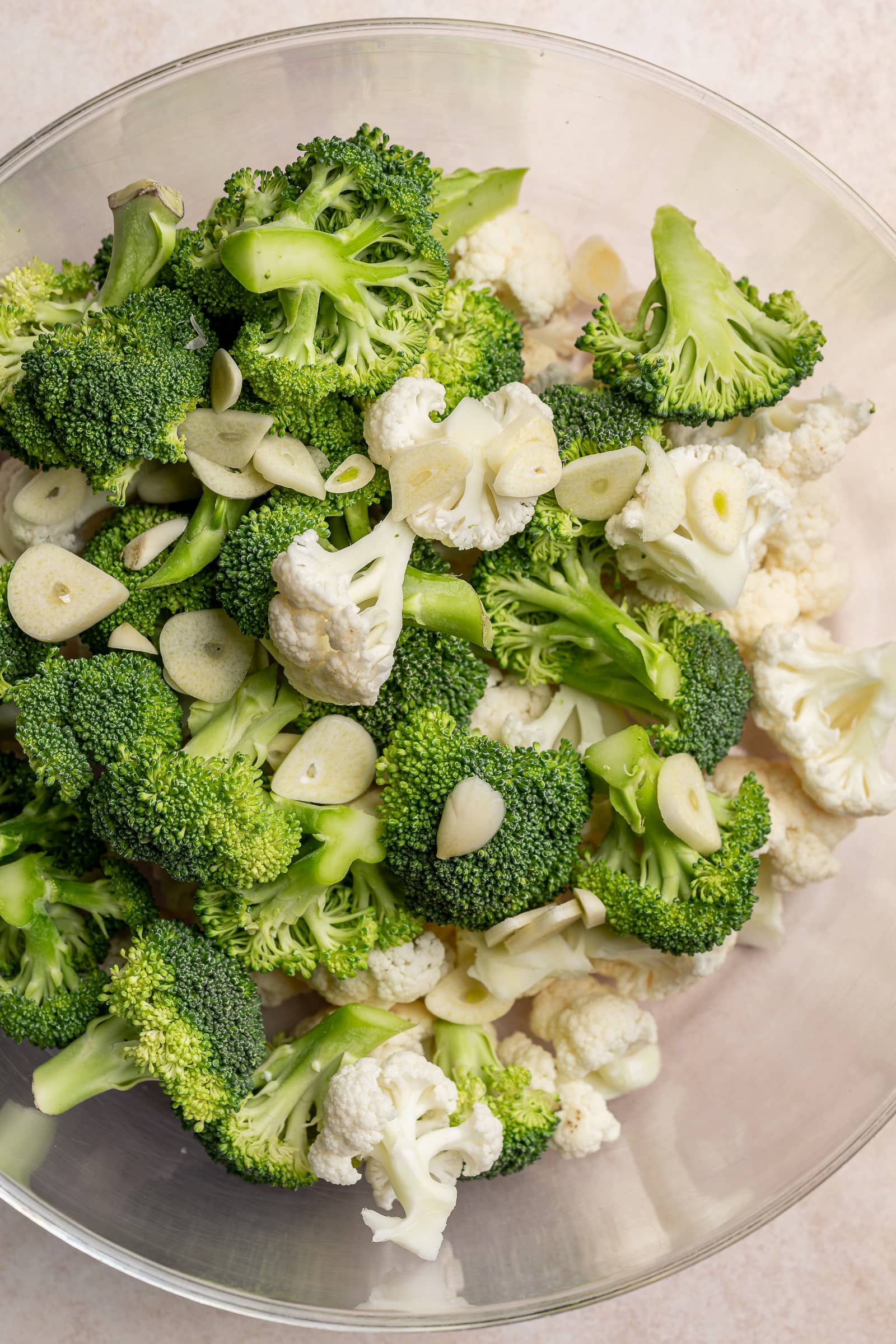 garlic, broccoli, and cauliflower in a large bowl.