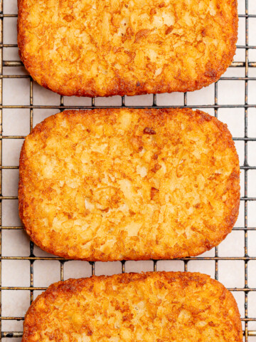 Crispy, air-fried hash browns on a wire rack.