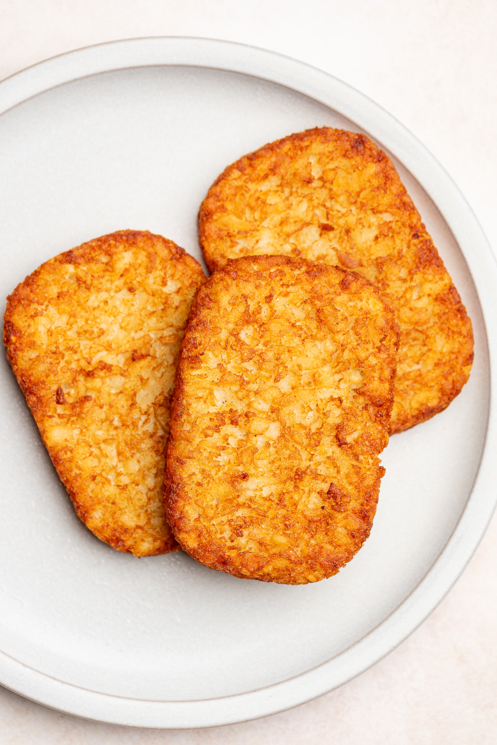 Crispy air-fried hash browns on a serving plate.