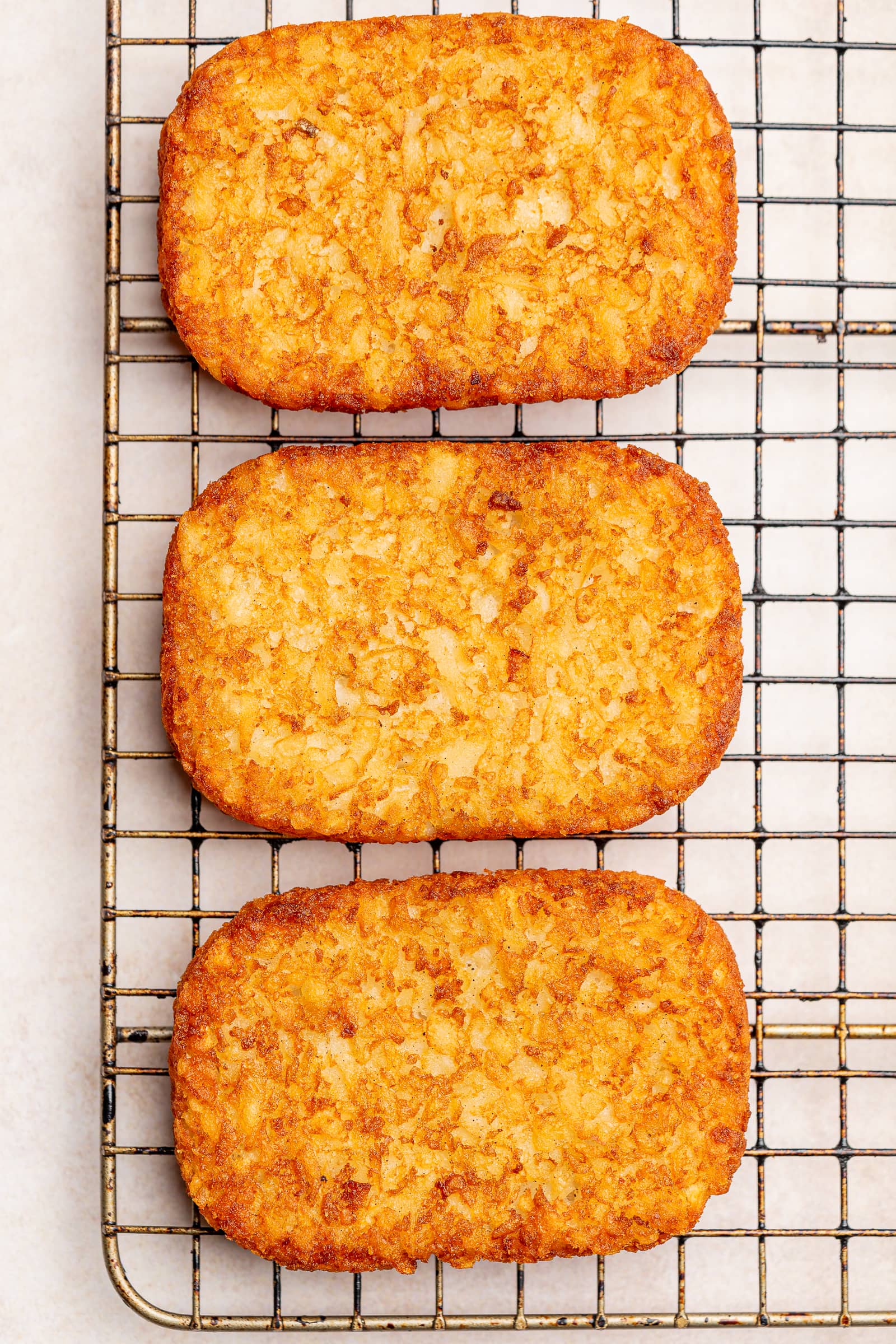 Crispy, air-fried hash browns on a wire rack.