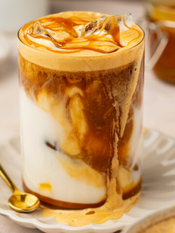 Iced caramel latte with a caramel drizzle on top.