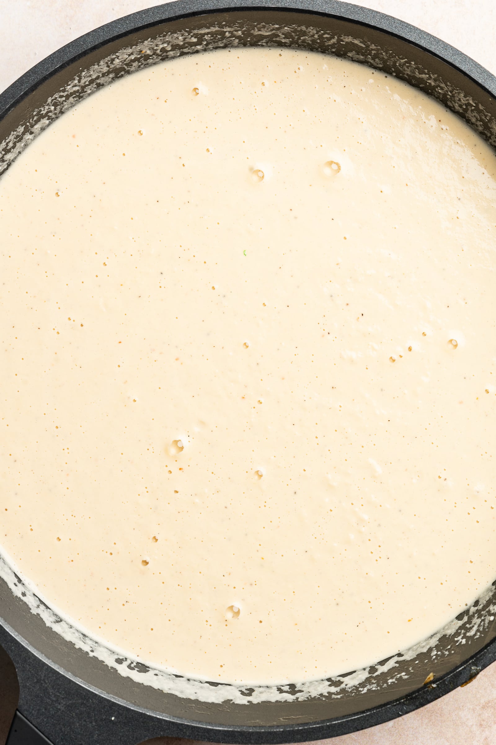 Blended cashew alfredo sauce in a large pan.