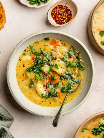 Vegan gnocchi soup in serving bowls garnished with parsley.
