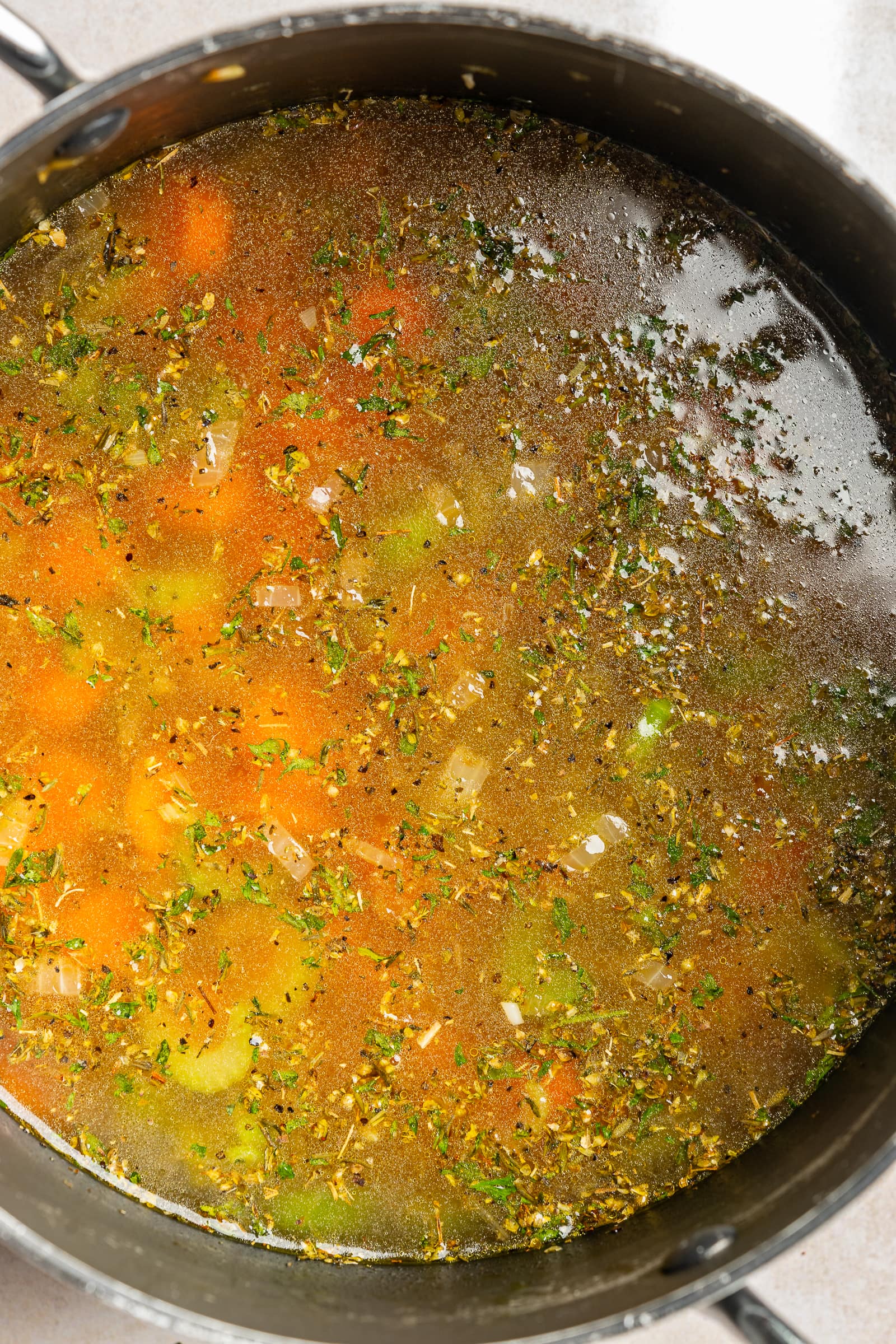 Vegetable broth added to a large soup pot.