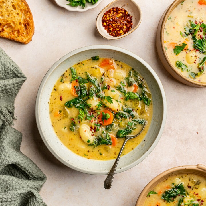 Vegan gnocchi soup in serving bowls garnished with parsley.