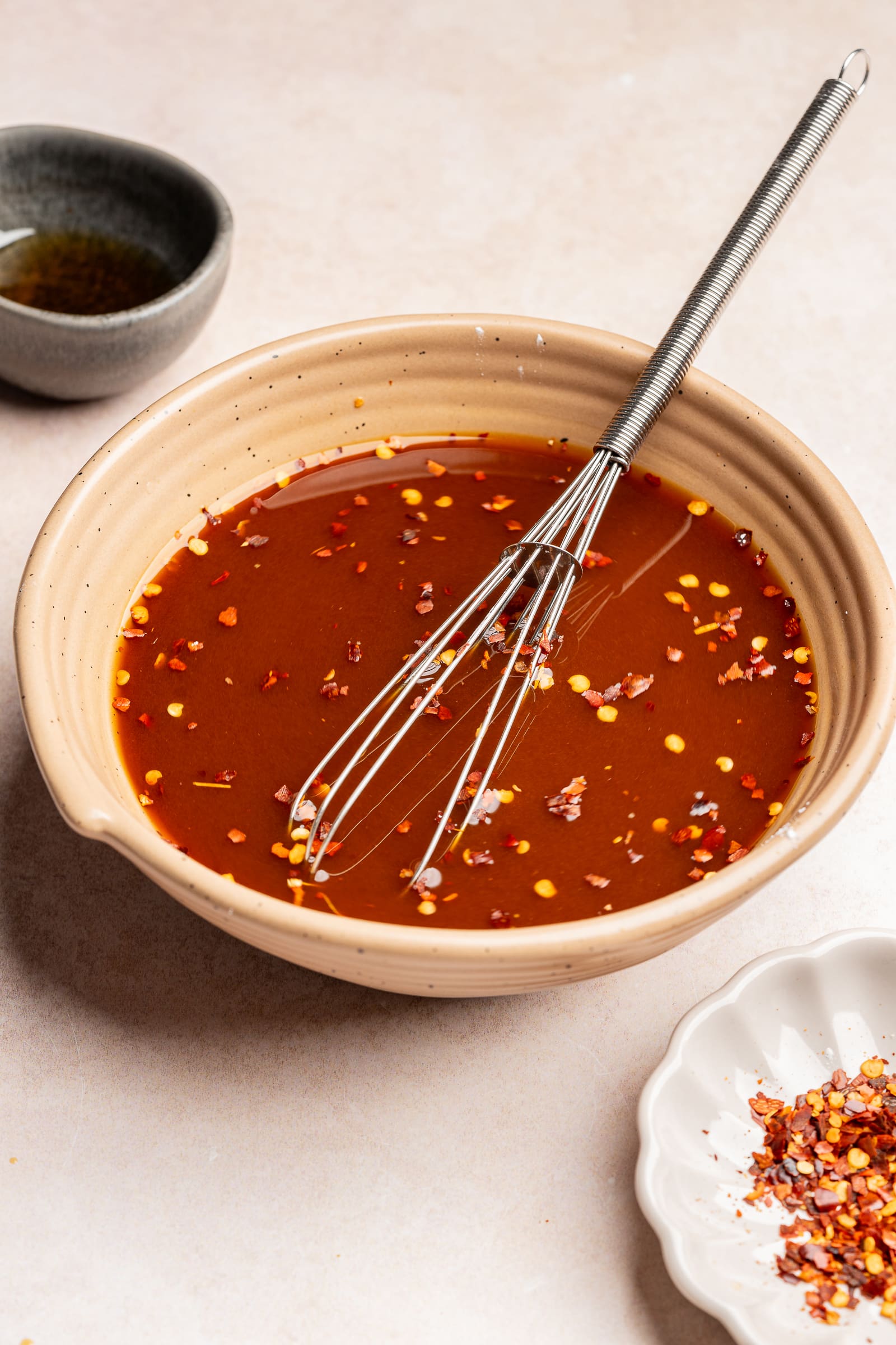 Stir fry sauce being whisked together in a bowl.