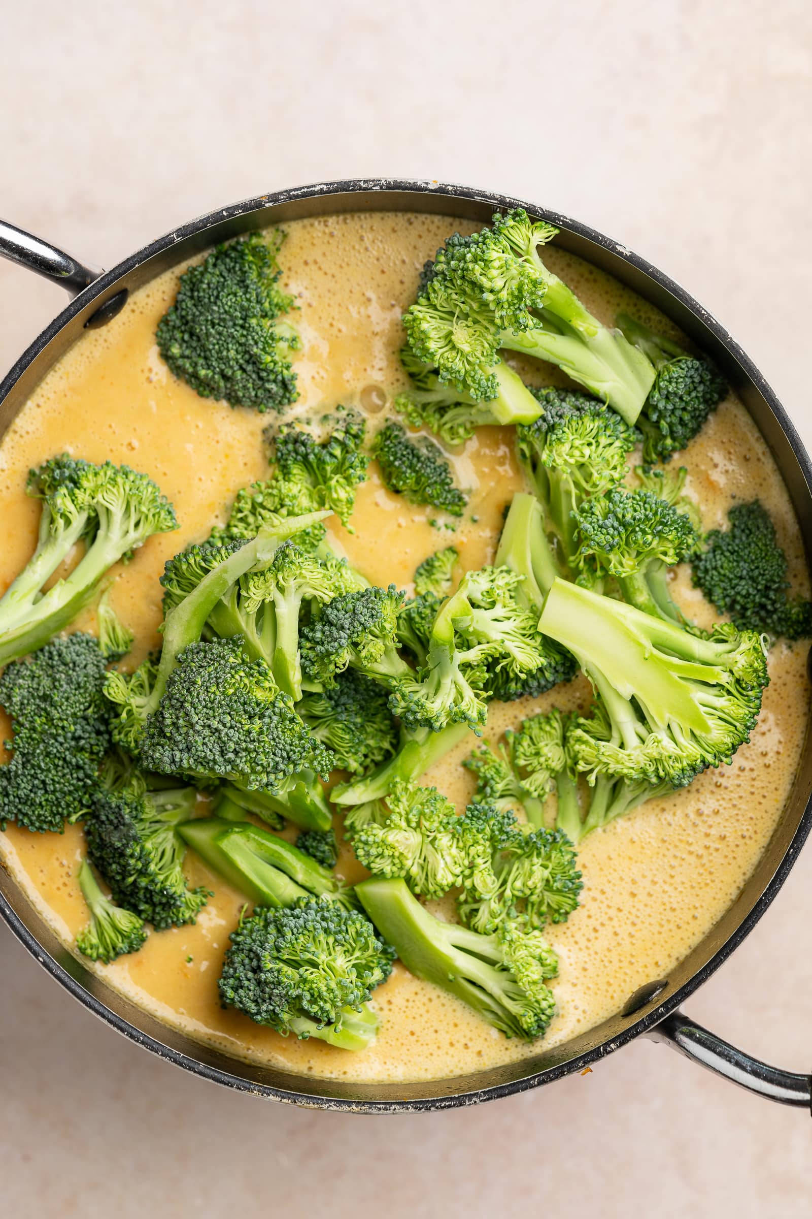 Broccoli added to soup pot.