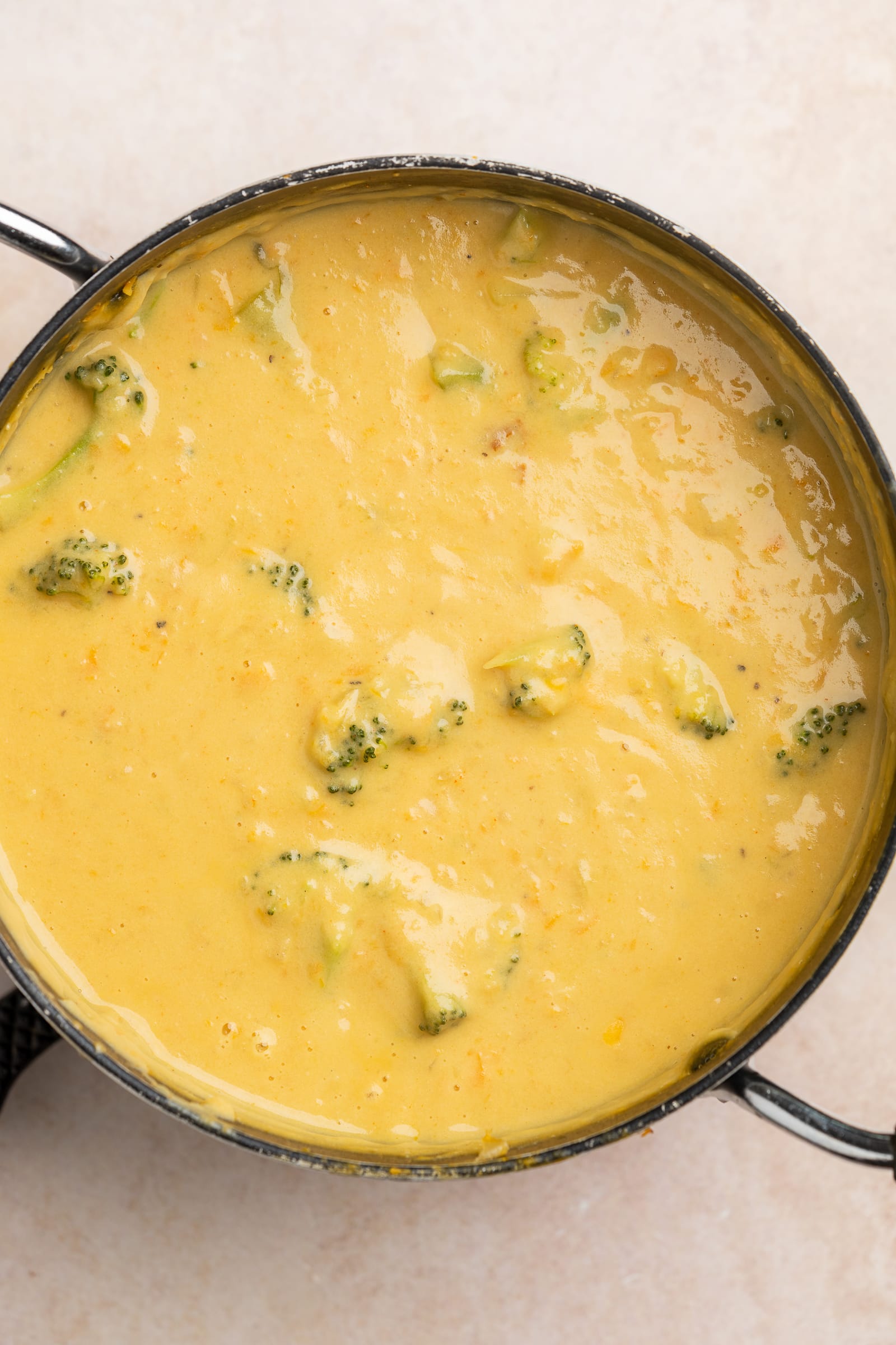 Vegan broccoli cheese soup in a soup pot.