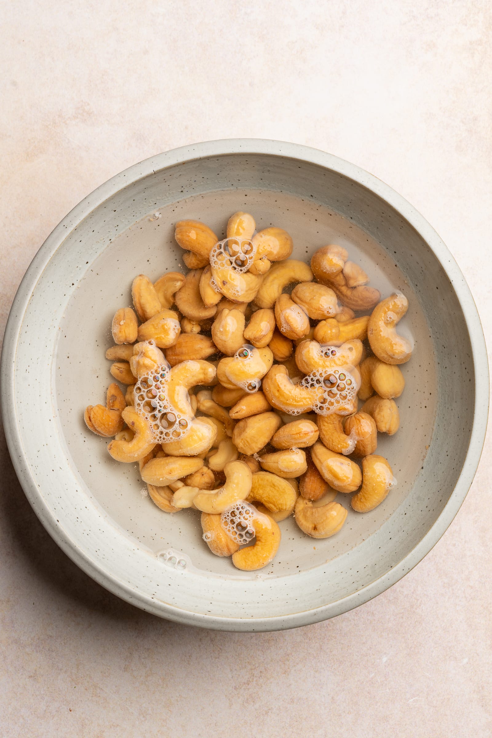 Cashews in a bowl of water.