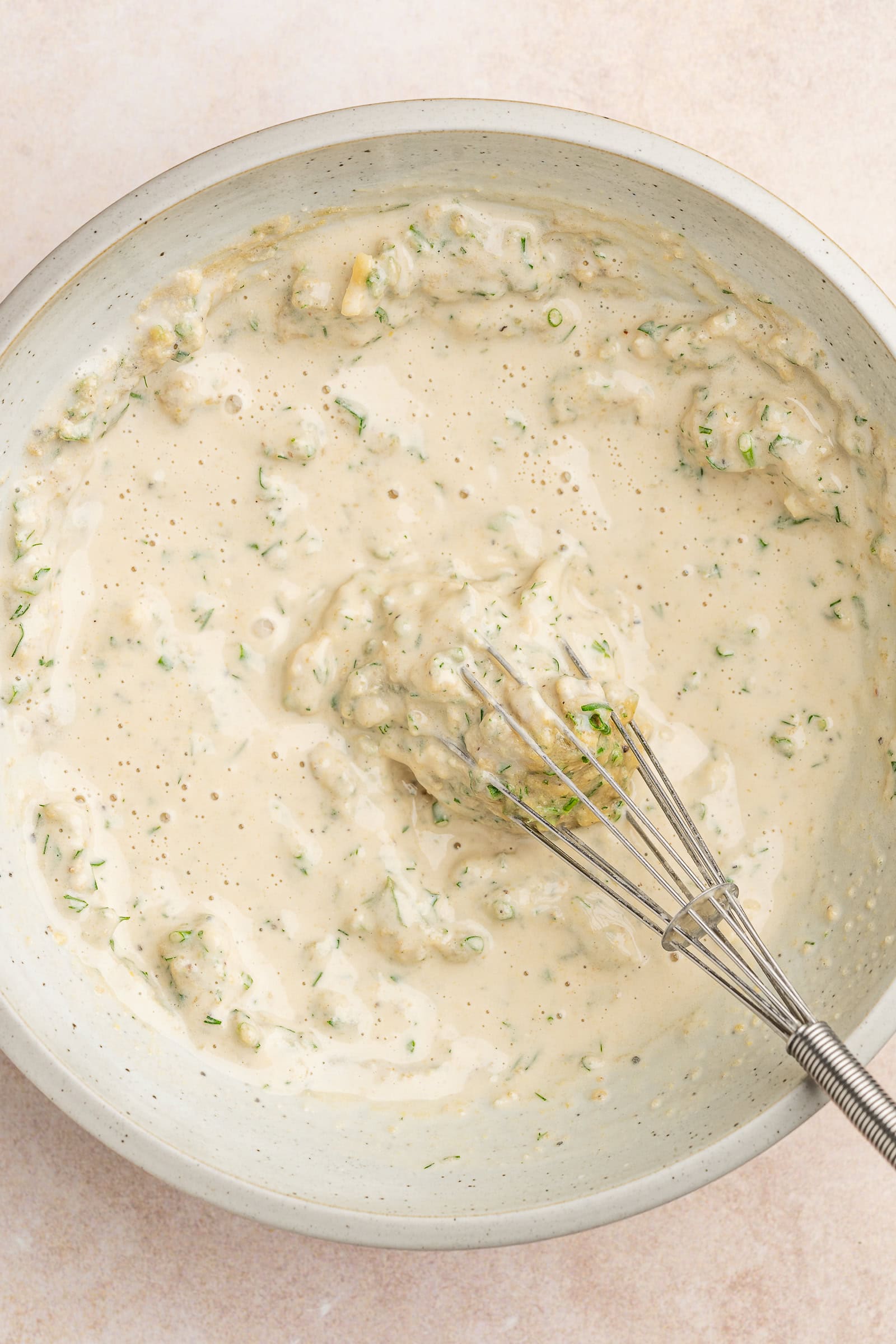 Tahini ranch dressing being mixed with water.