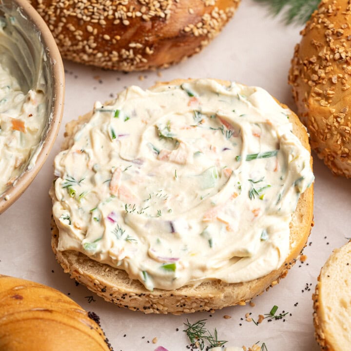 Vegetable tofu cream cheese smeared onto an everything bagel.
