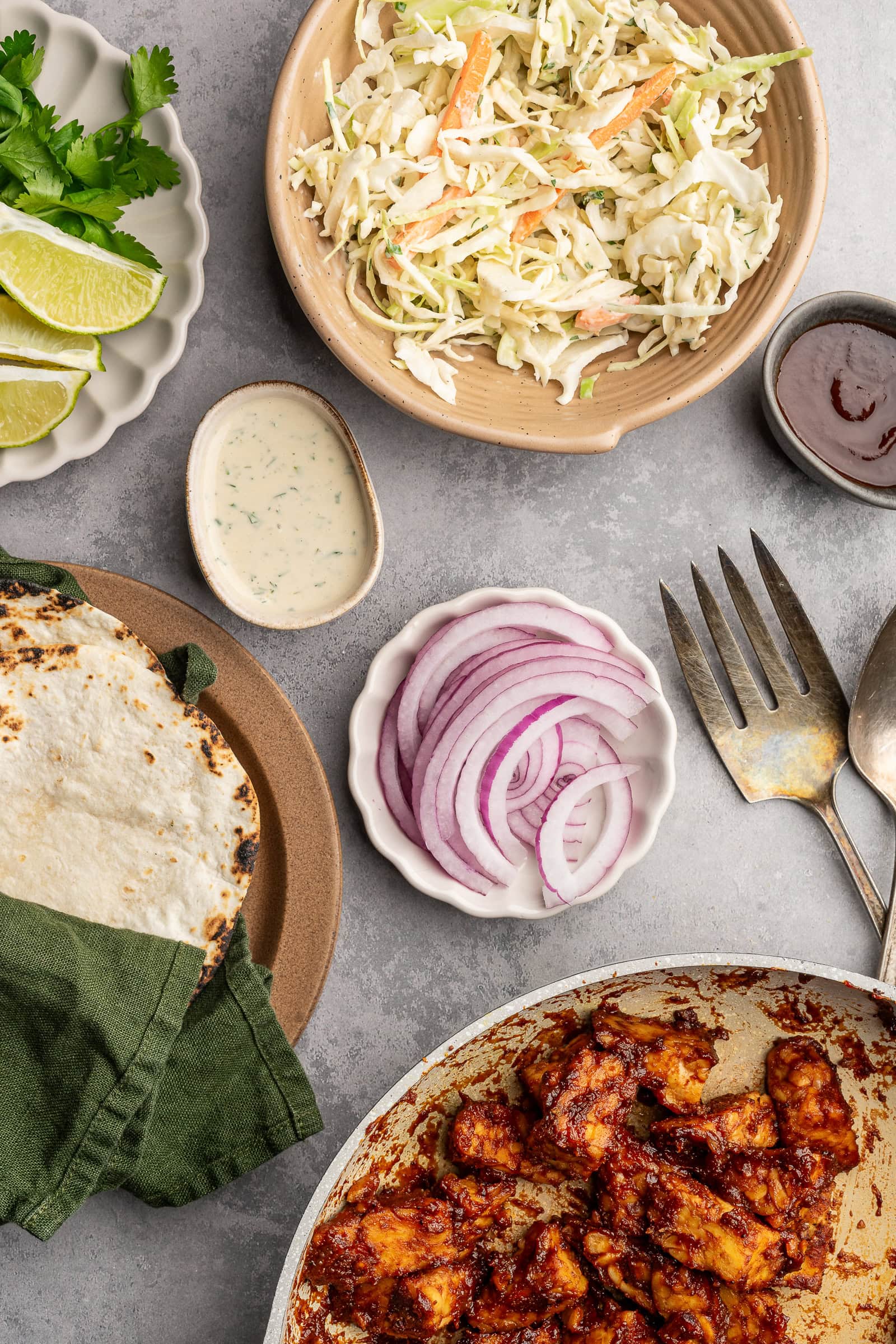 Taco ingredients in individual plates and servings.