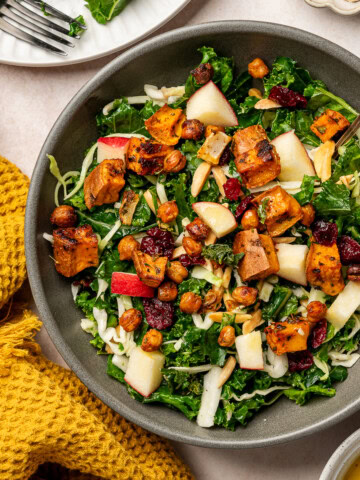 Kale crunch salad with additional toppings like sweet potatoes, cranberries, and apples.