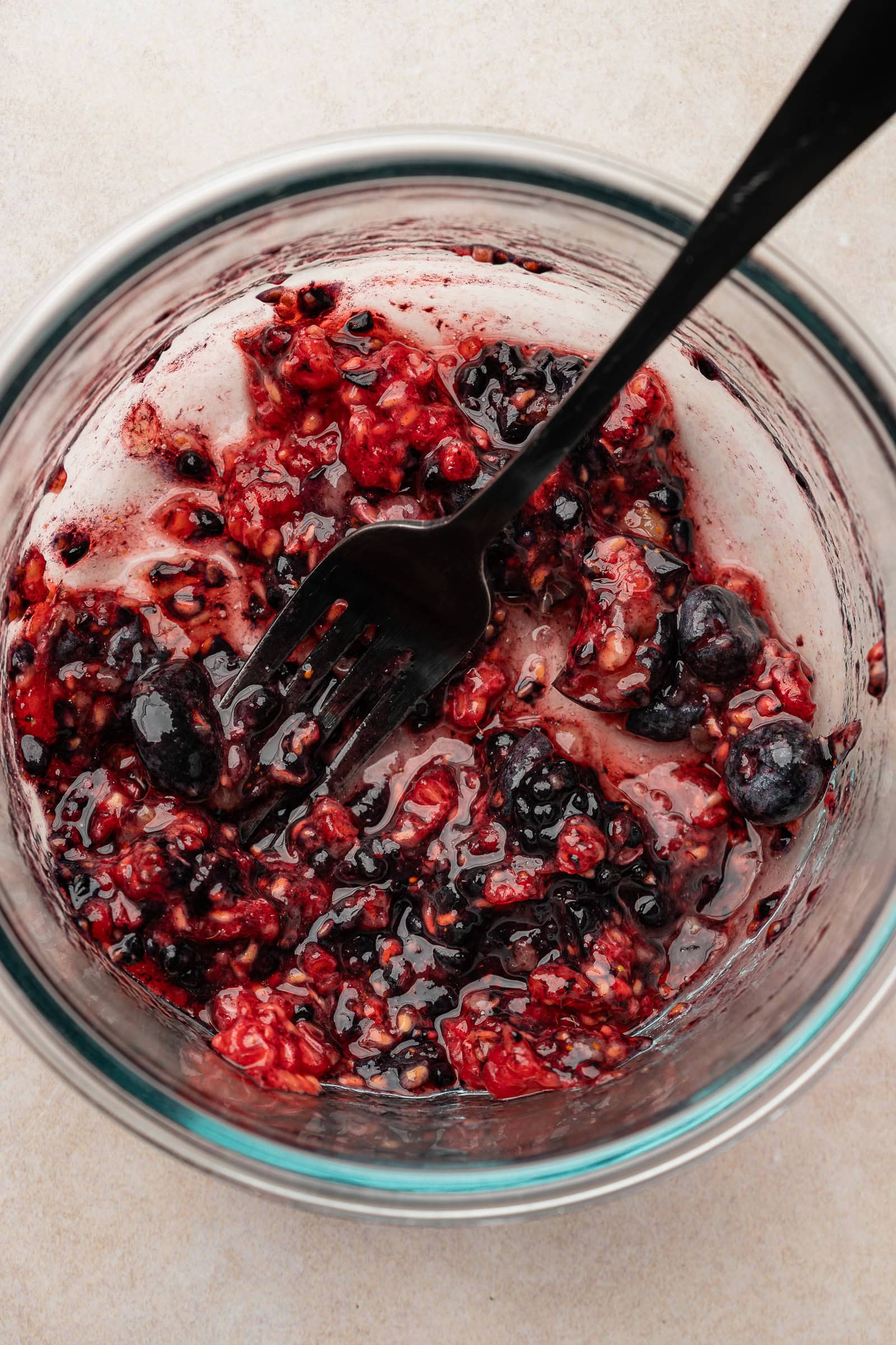 Mashed berries in a small container.