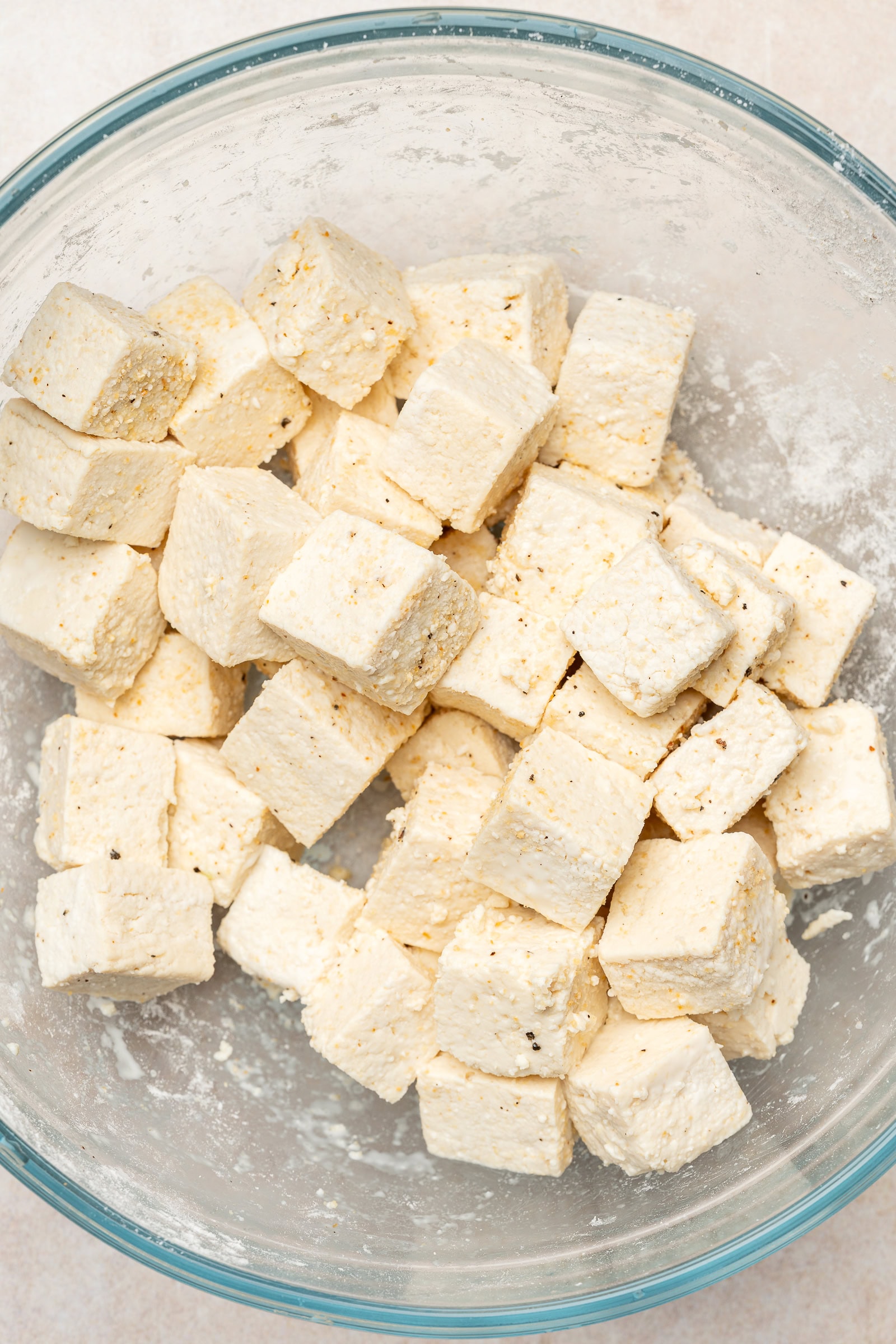 Tofu cubes tossed into cornstarch and seasoning.