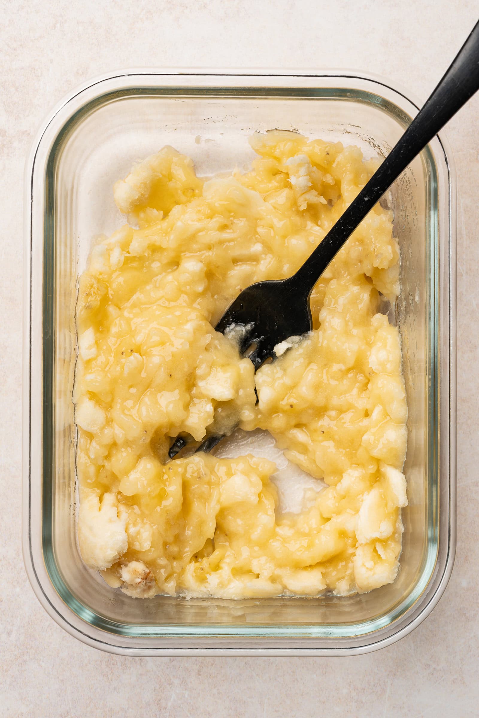Mashed banana in a container.