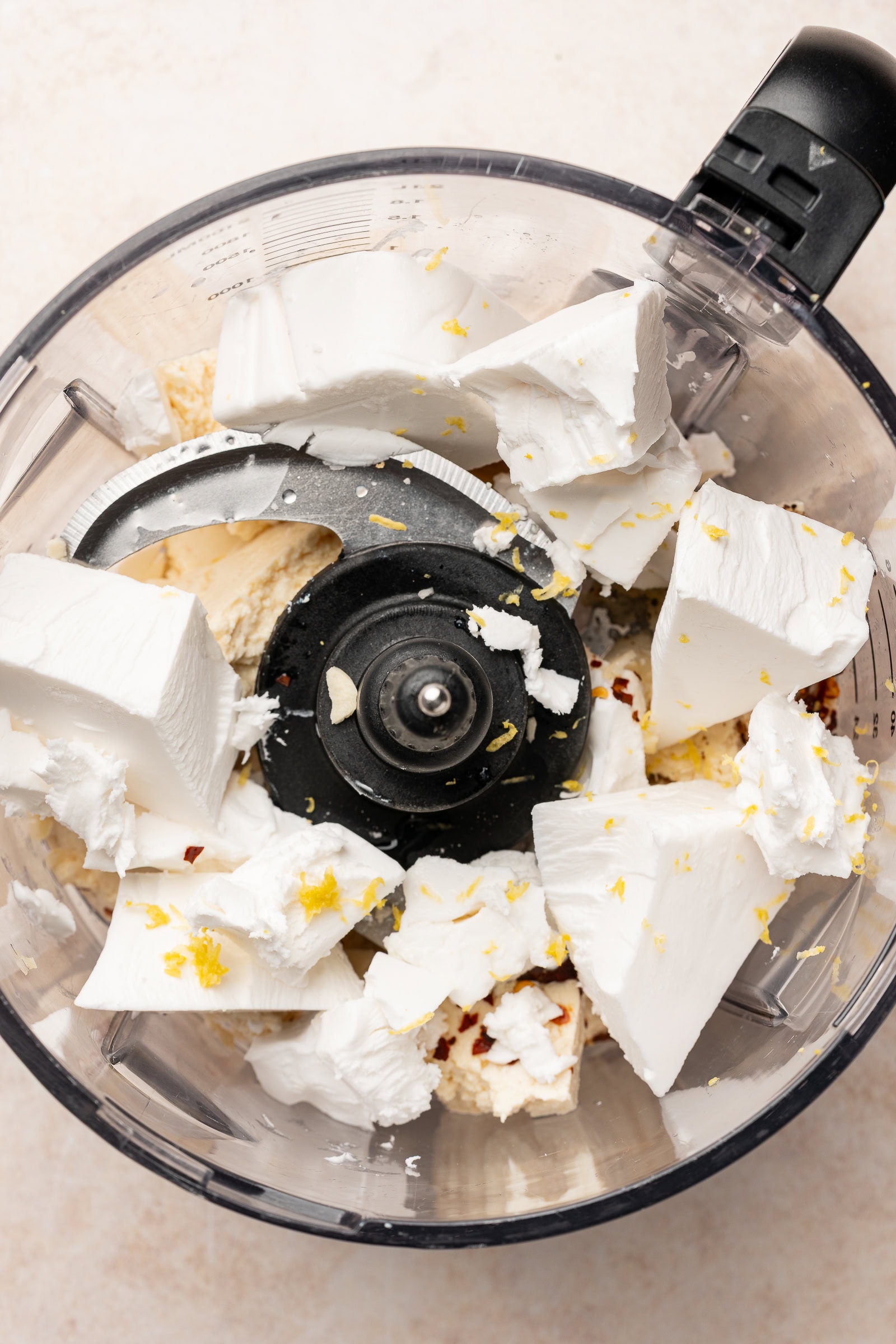 Vegan whipped feta ingredients in a food processor.