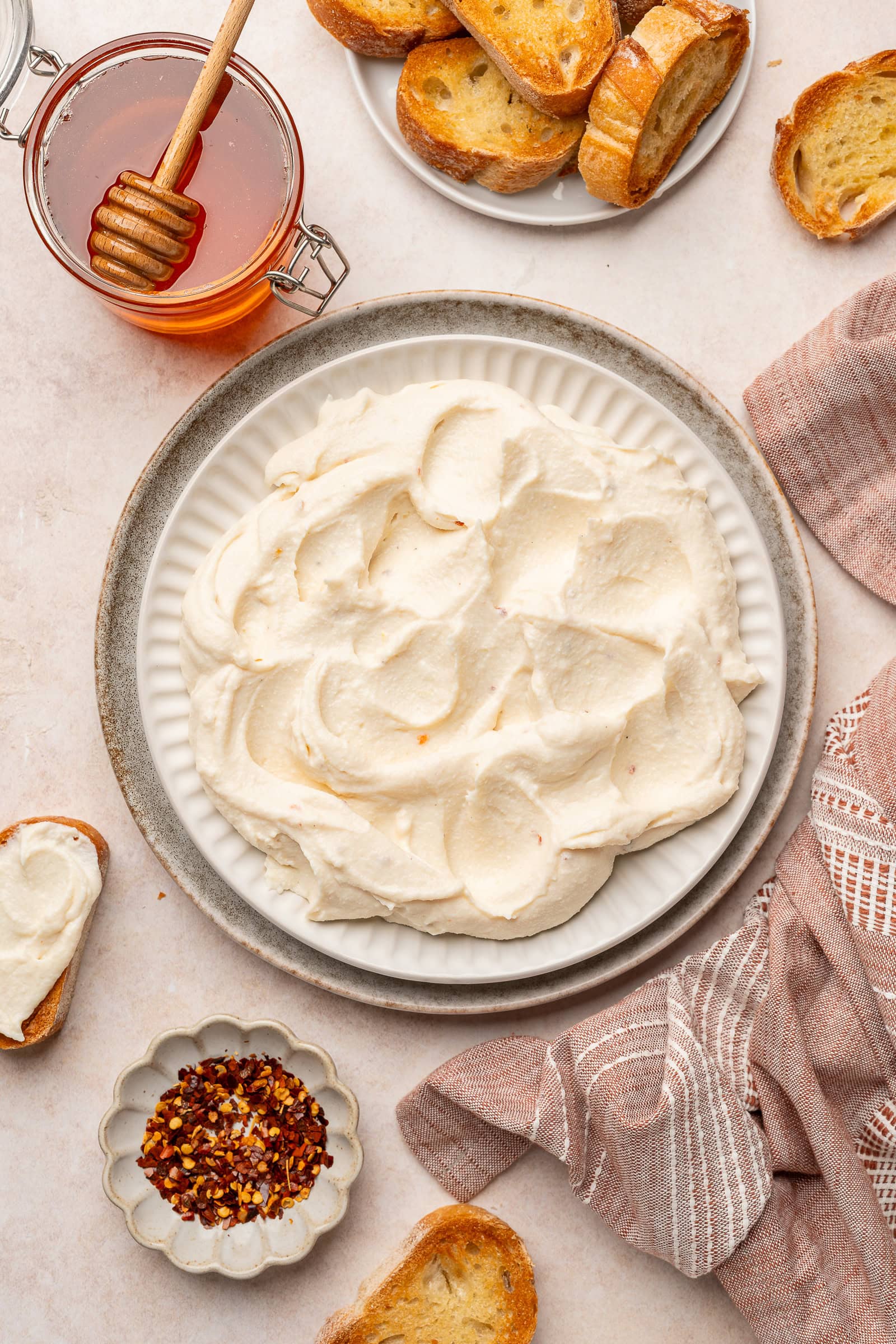 Vegan feta being plated on a serving dish.