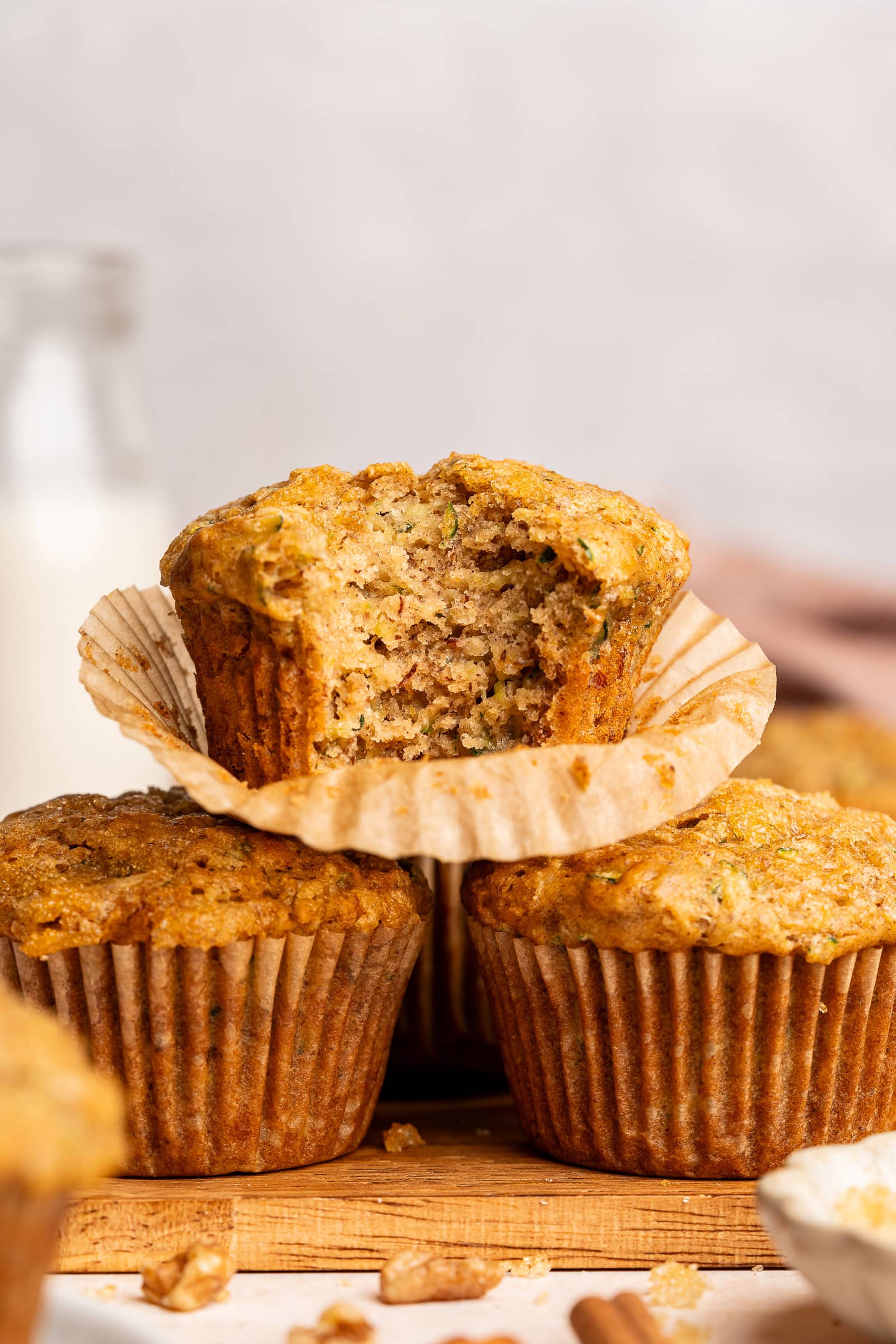 A stack of zucchini muffins with a bite missing.