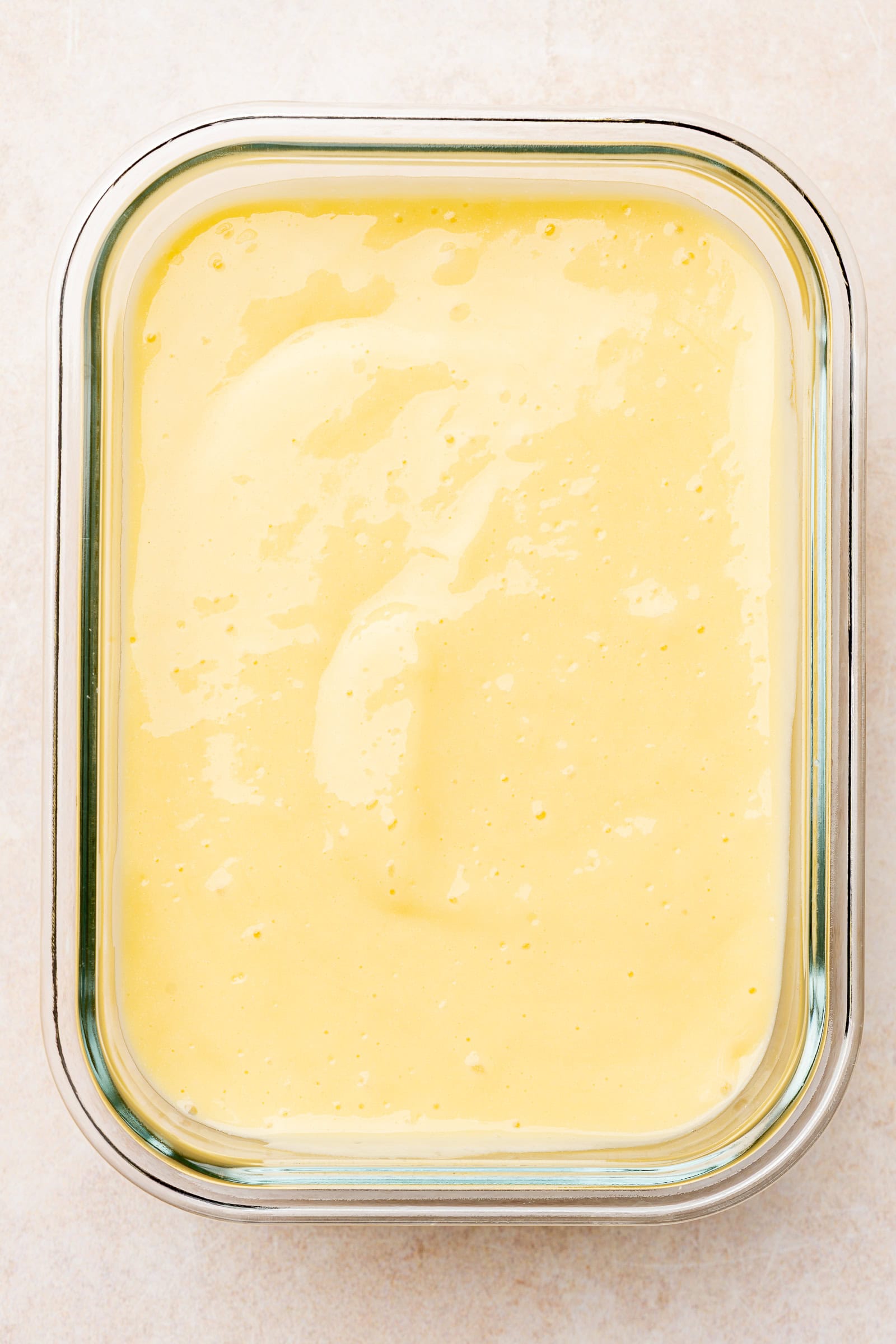 Thick mango coconut mixture in a food storage container.
