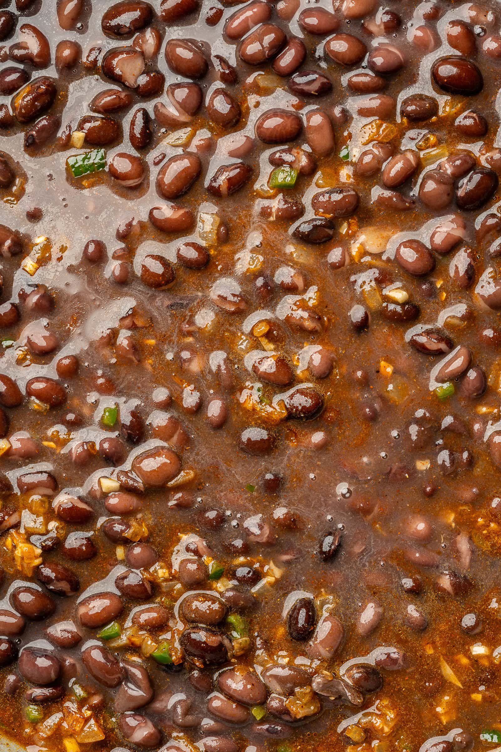 Black beans added to frying with sautéed onion and spices.