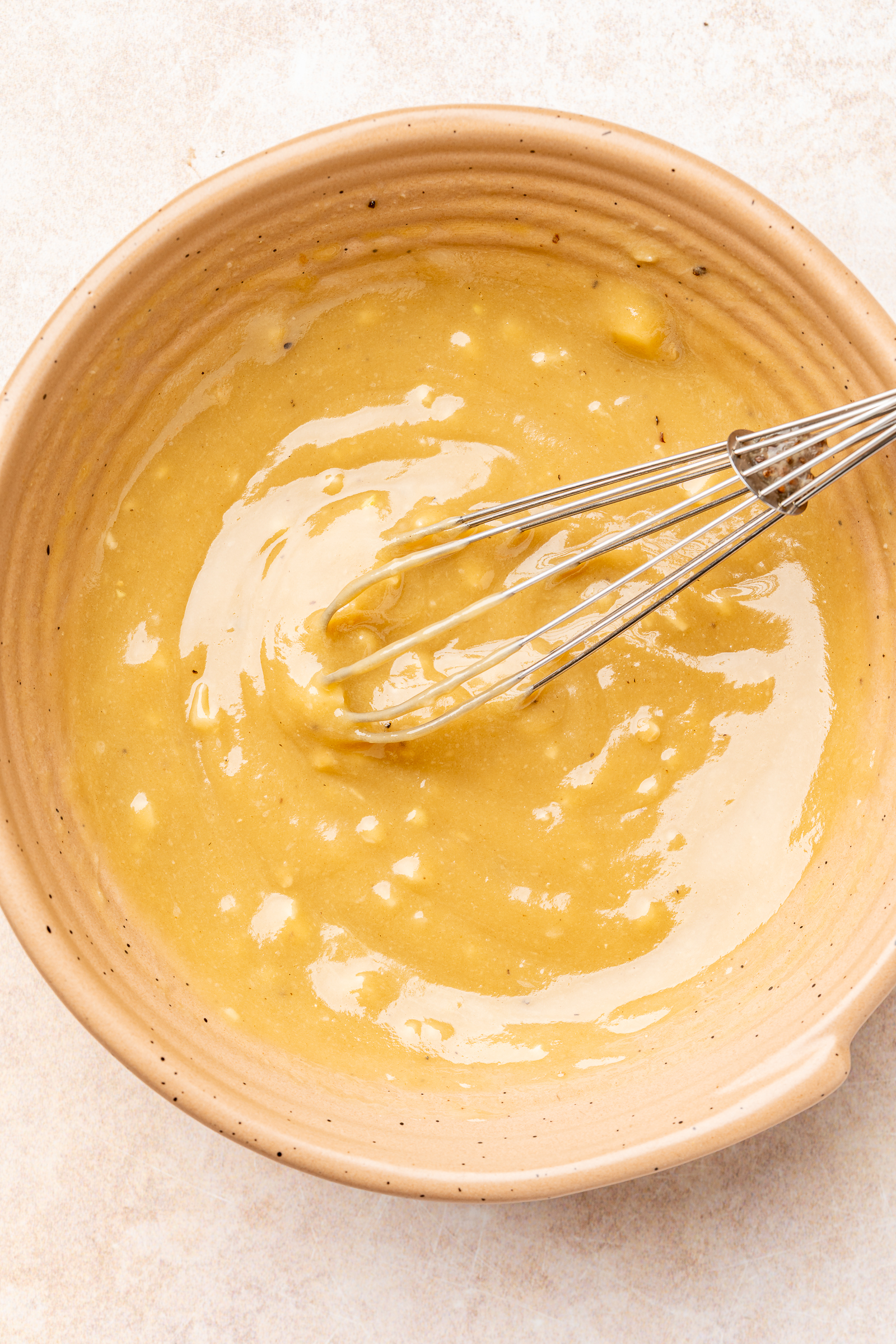 Tahini salad dressing being whisked together.