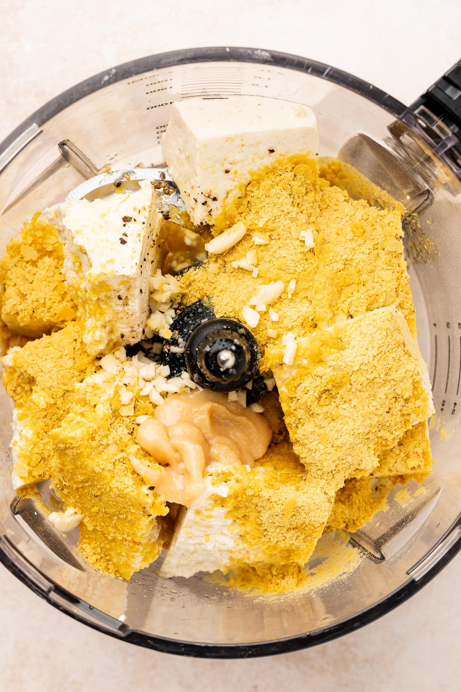 Tofu ricotta ingredients in a food processor before being blended.