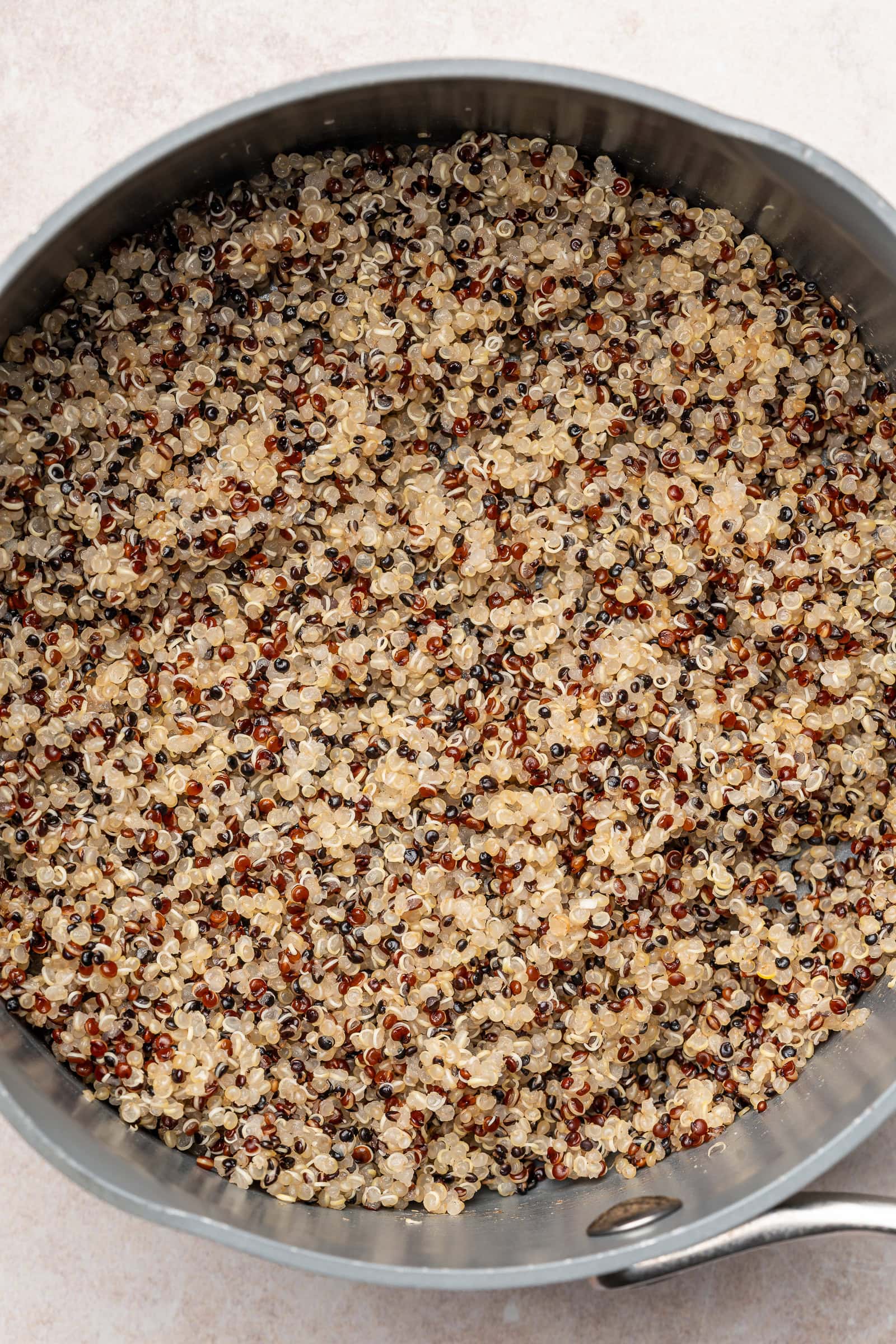 Cooked tri-color quinoa in a pan.