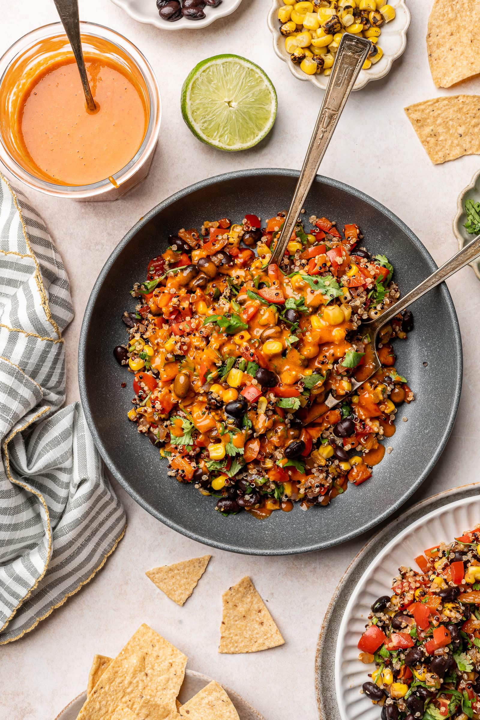 Sauce being added to an individual portion of the black bean quinoa salad.
