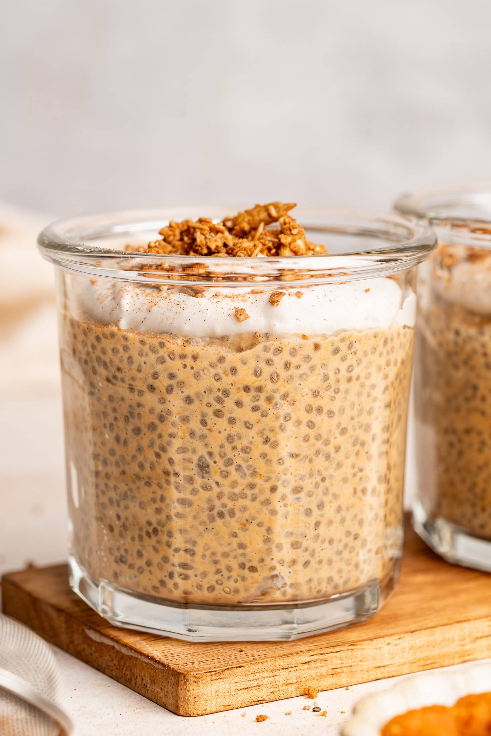 Set chia pudding in a glass jar topped with coconut whipped cream and granola.