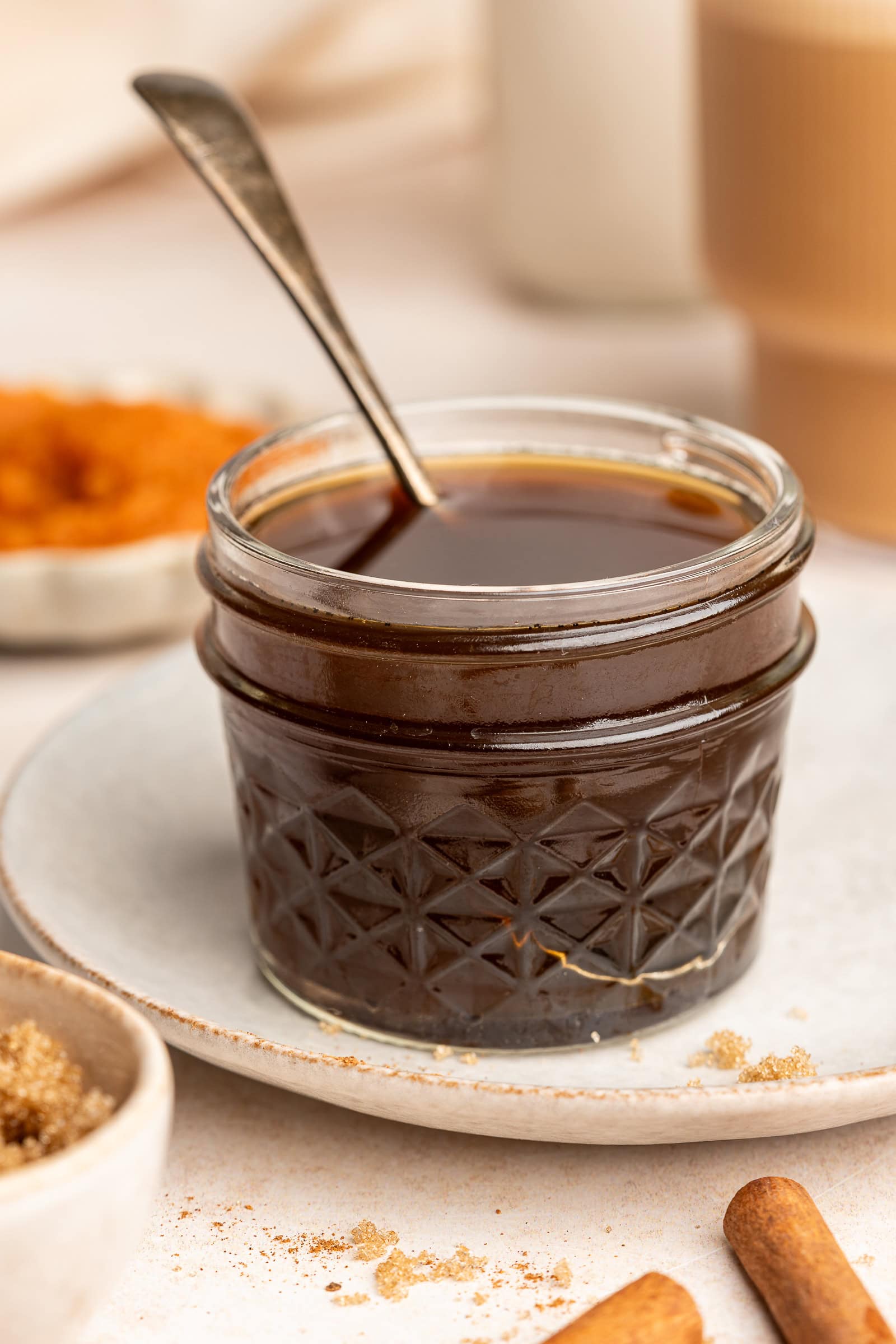 Pumpkin spice syrup in a small jar with a serving spoon.