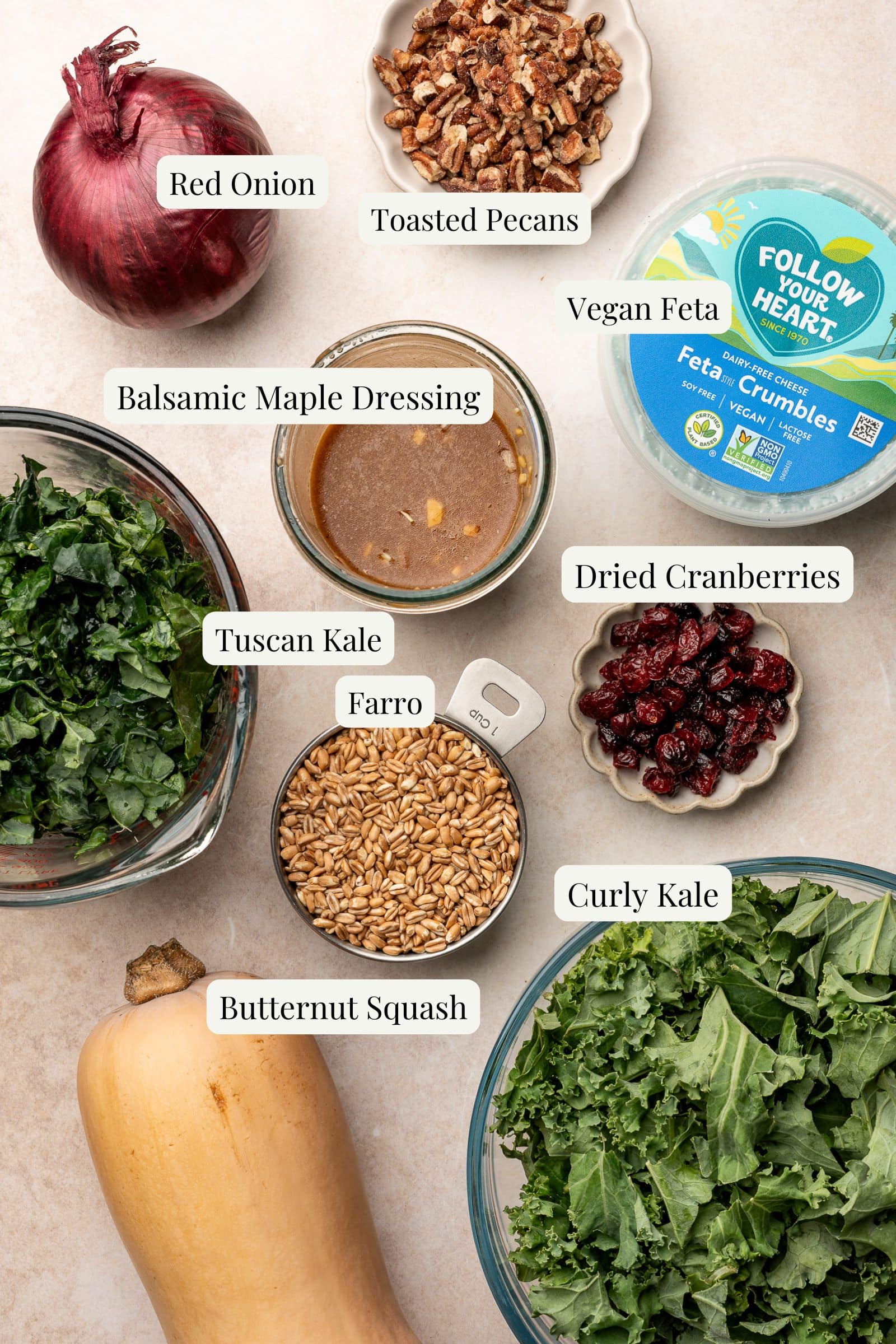 Labeled ingredients for a butternut squash and kale salad.