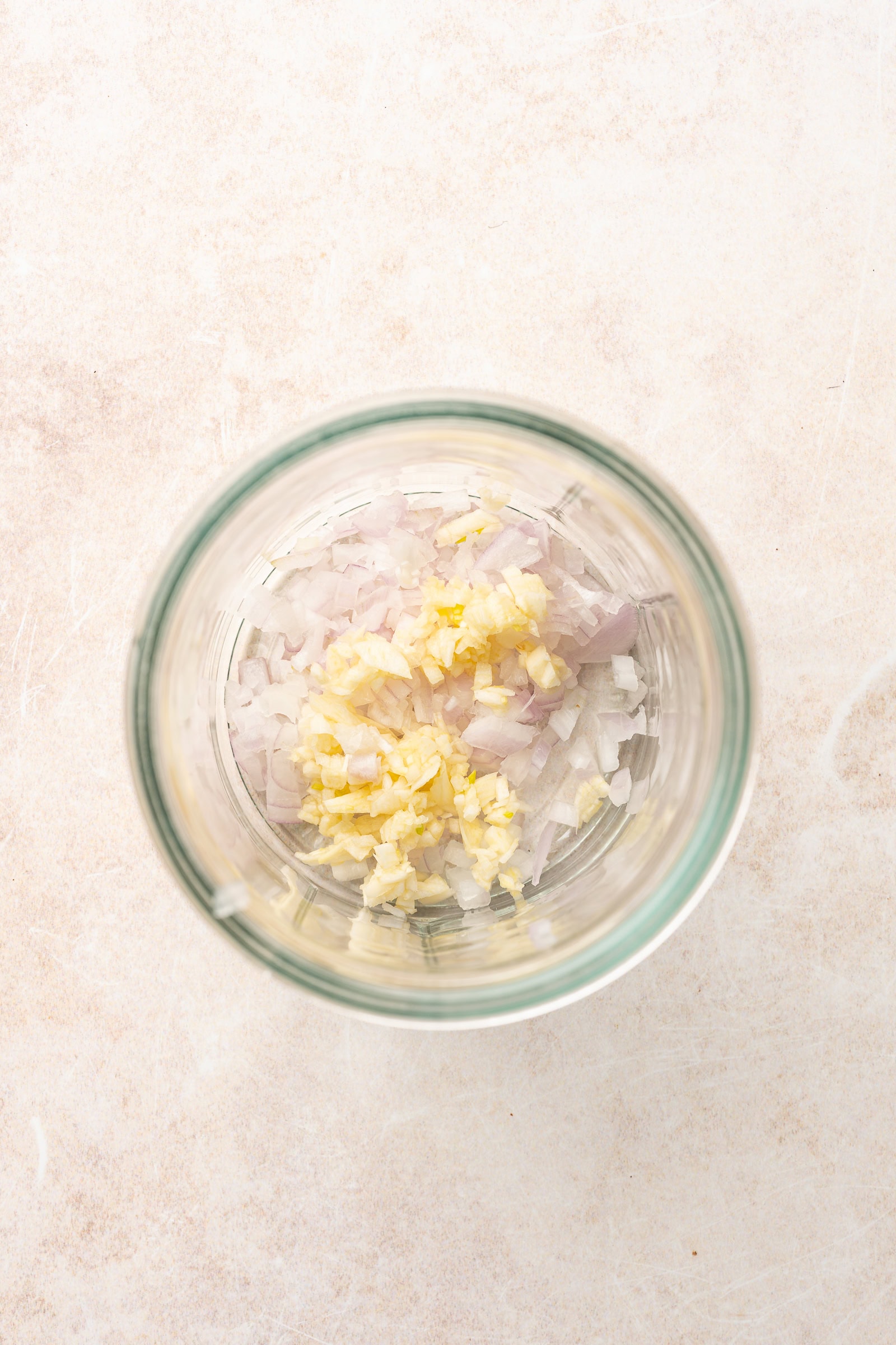Garlic and shallot in a glass jar.