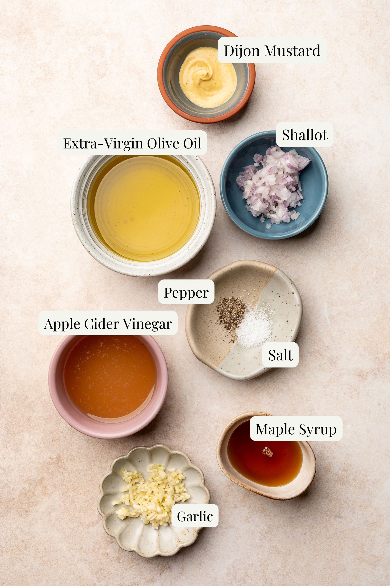Labeled ingredients individually portioned for apple cider vinaigrette.