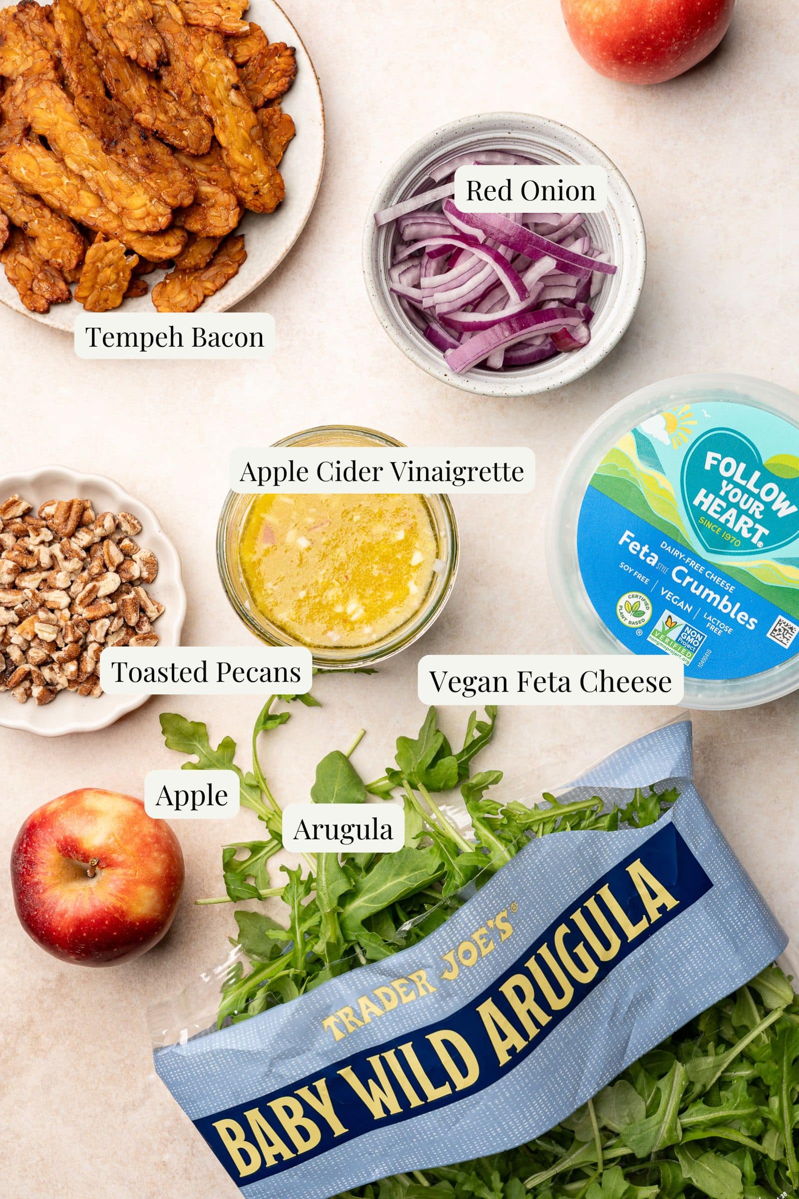 Labeled ingredients for apple arugula salad.
