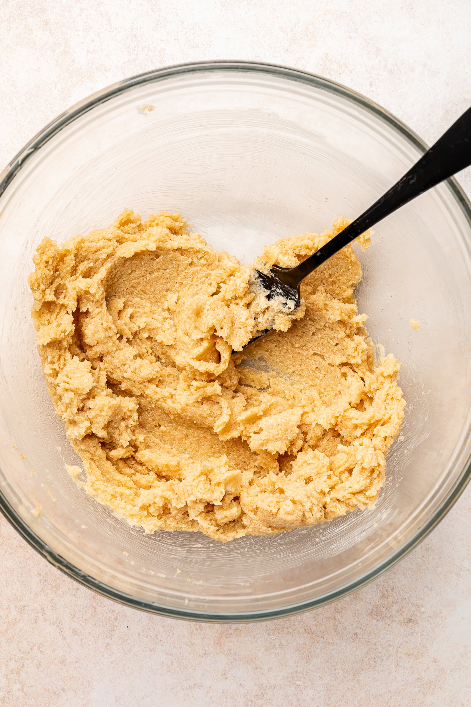 Butter and sugar being creamed together in large bowl.