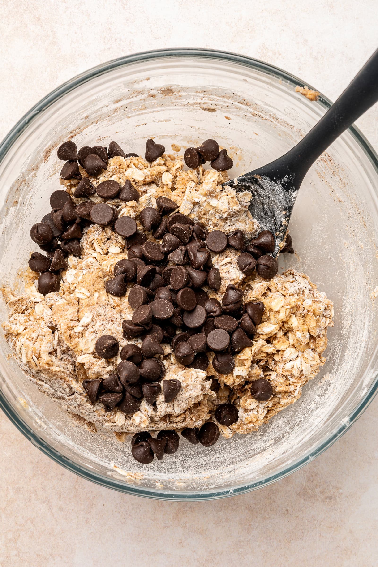 Dry ingredients partially mixed, and chocolate chips being added.
