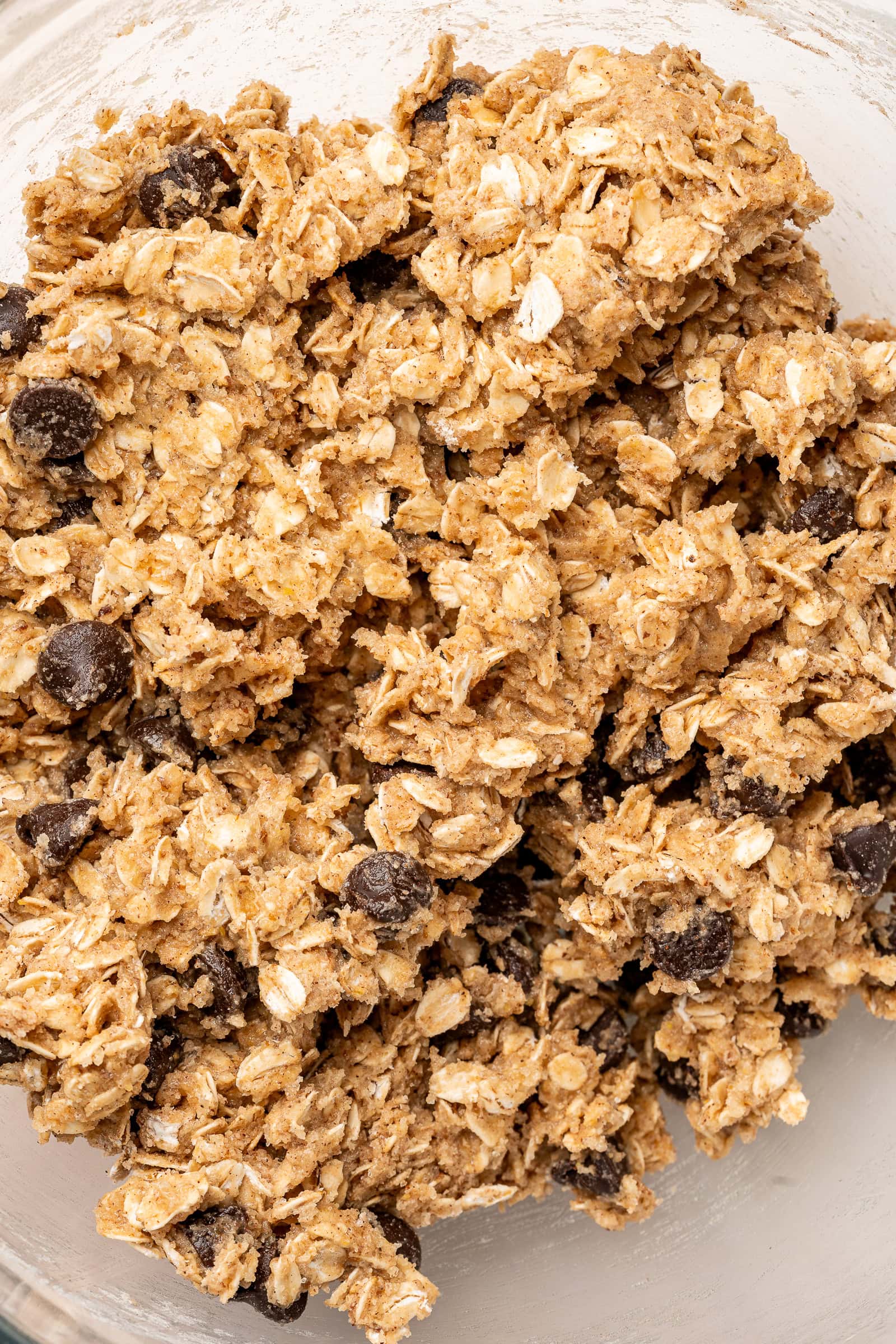 Oatmeal chocolate chip cookie batter in large bowl.