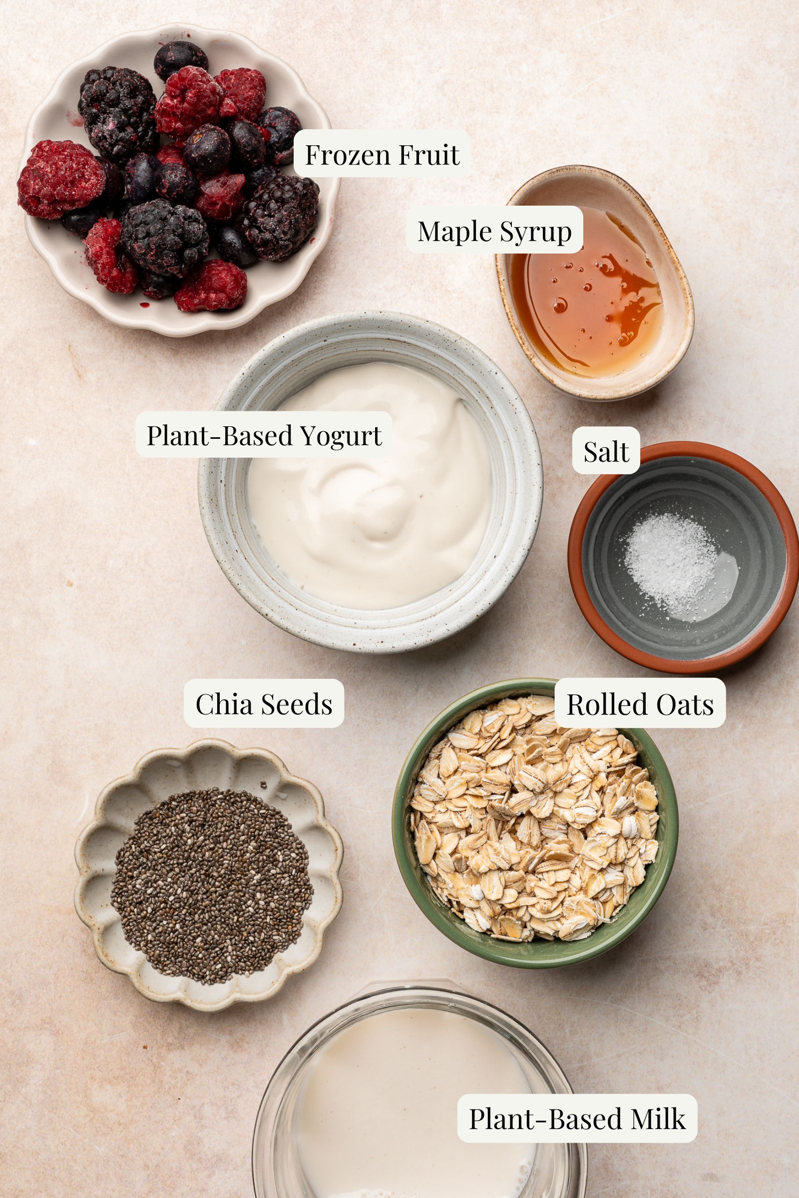 Labeled ingredients for overnight oats with frozen fruit.