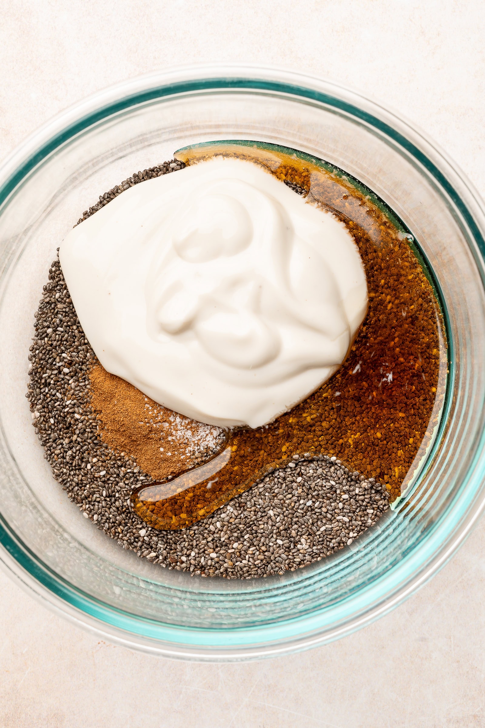 Oat milk chia pudding ingredients being added into bowl.