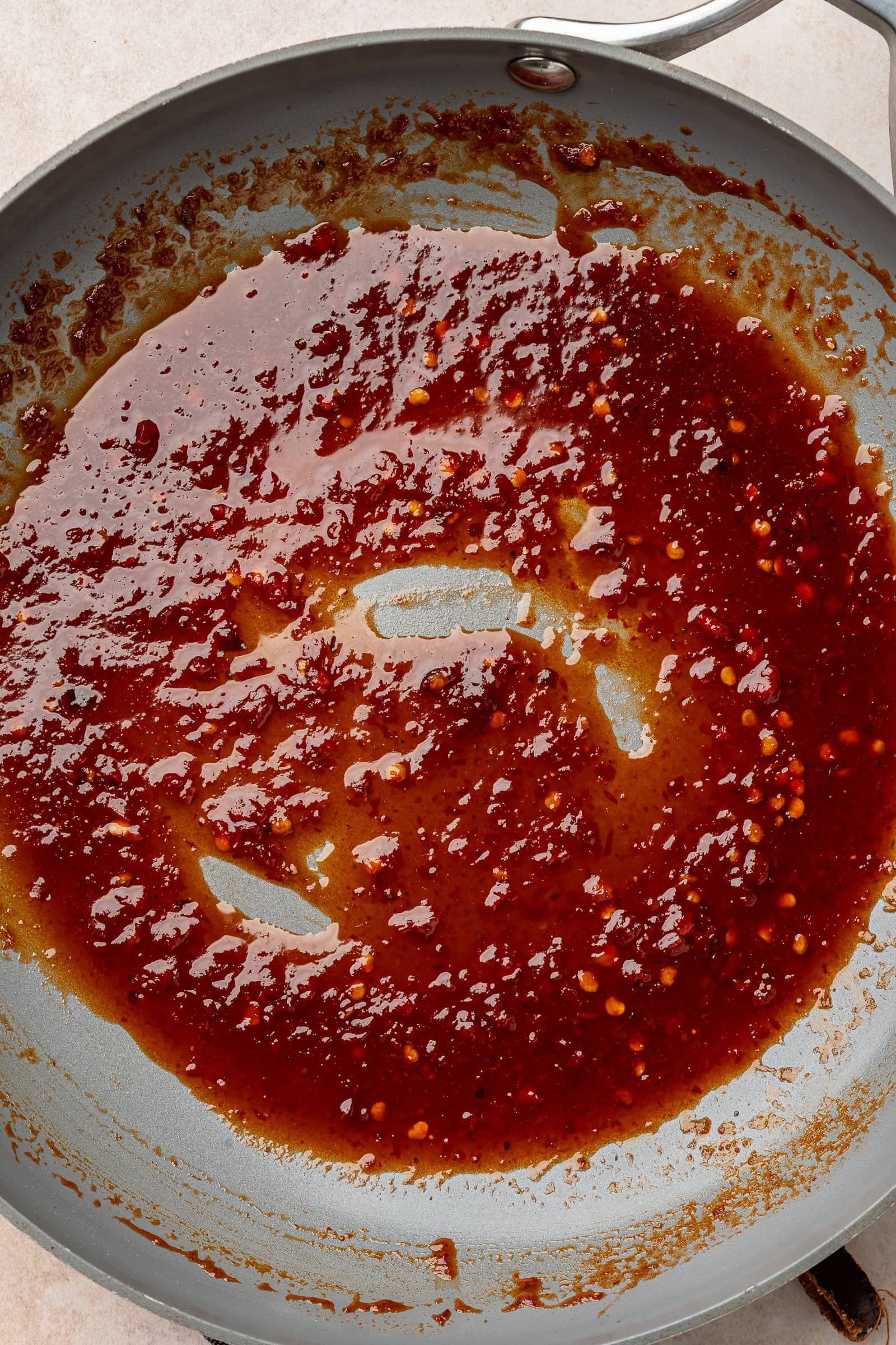 Harissa glaze cooked down in frying pan until thickened.